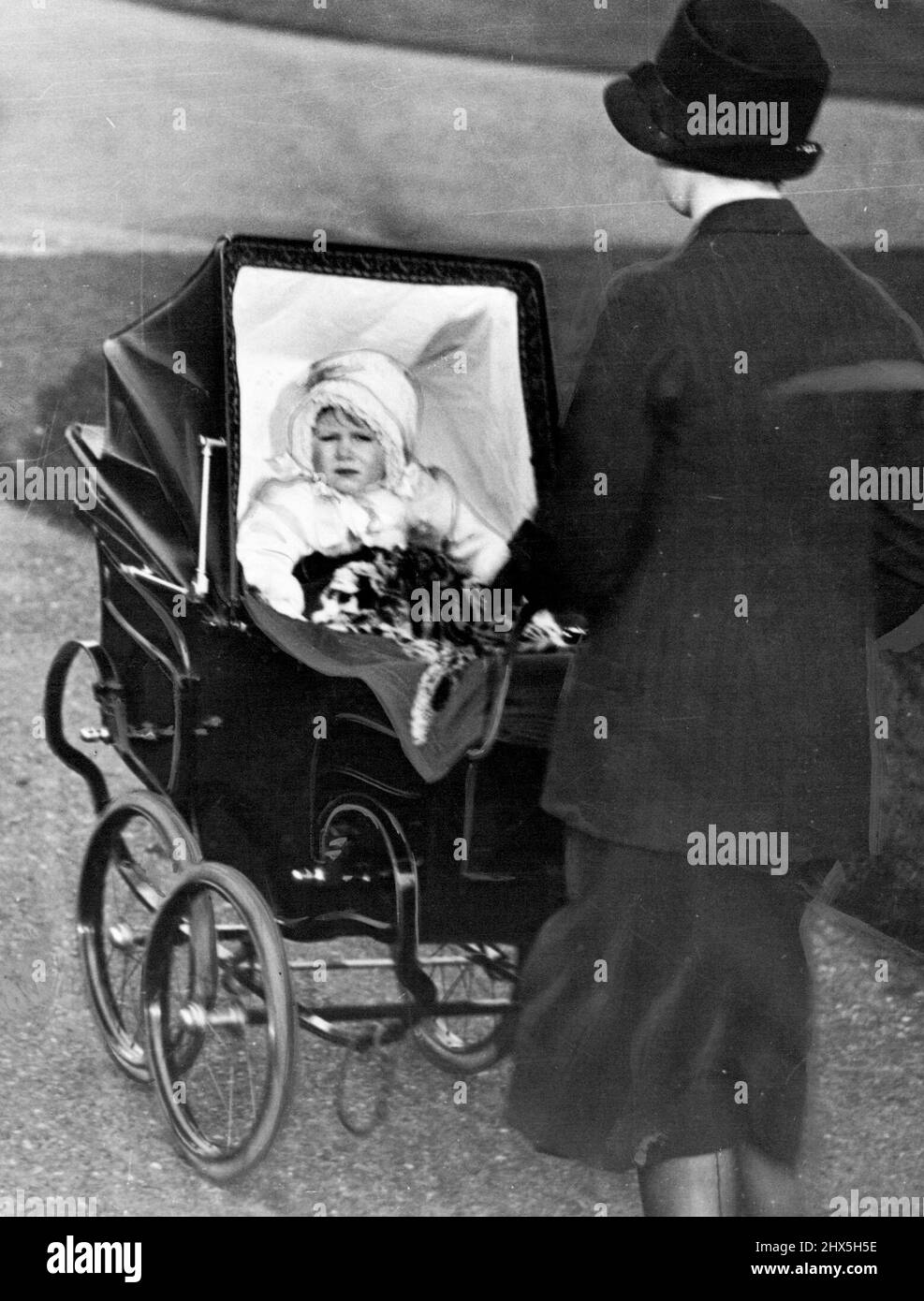 Princess Elizabeth's Pram - Princess Elizabeth as a baby riding in the perambulator which will be used by her own child. Princess Elizabeth's baby, which it is expected will be born at Buckingham Palace in the middle of this month, will have the Princess's own perambulator cots and cradle. November 05, 1948. Stock Photo