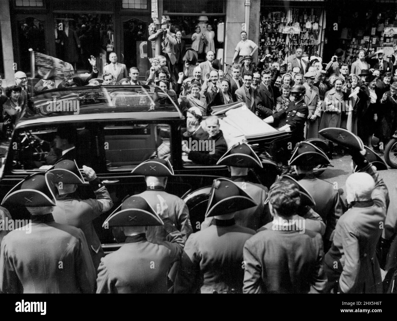 Pensioners See Their Queen. Chelsea Pensioners from the Royal, Hospital look on as the Queen and the Duke of Edinburgh are driven along King's Road, Chelsea, during the second of their Coronation week drives through the streets of London. June 2, 1953. Stock Photo