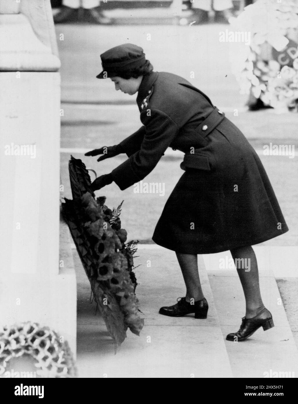 Princess Places Her Wreath on Cenotaph. Princess Elizabeth, in W.R.A.C. uniform placing her wreath on the Cenotaph today (Remembrance Sunday). Beneath an autumn sun breaking through mist, the King, accompanied by Princess Elizabeth and the Duke of Gloucester, led the nation's homage to the dead of two world wars in solemn, impressive ceremonial at the Cenotaph, in Whitehall, London, to-day. (Remembrance Sunday). November 6, 1949. (Photo by Reuterphoto). Stock Photo