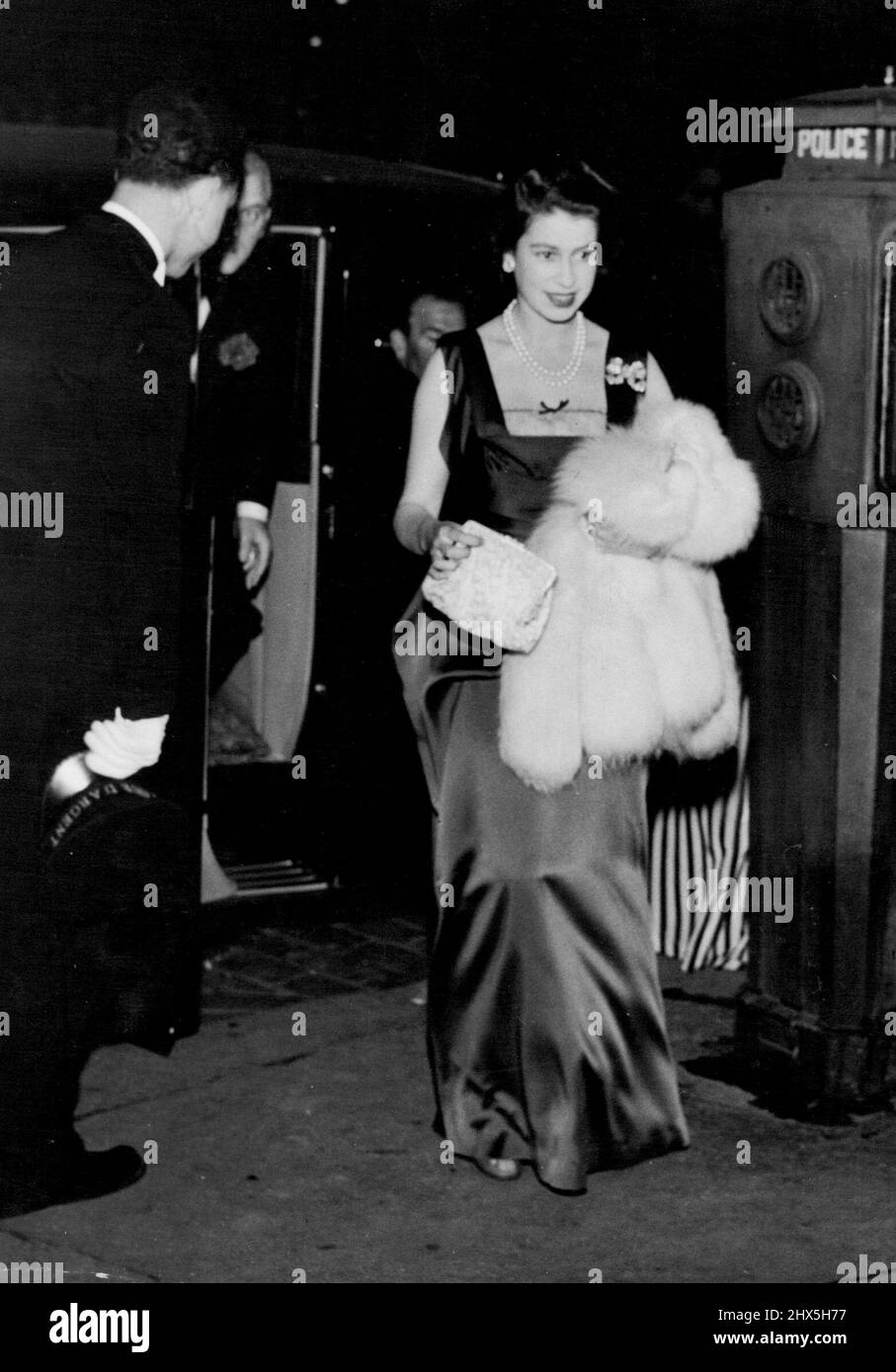 Princess Goes To Embassy Restaurant Party. Princess Elisabeth, wearing black and silver evening gown with white furs and bag to match, arriving at the Tour d'Argent Restaurant overlooking the back of Notre Dame Cathedral and the Seine, for a dinner party. Three-quarters of the accommodation was reserved by the British Embassy. Before dining in the place of honour on the sixth floor, the Princess and the Duke of Edinburgh went down to the ancient cellars for aperitifs. May 18, 1948. Stock Photo