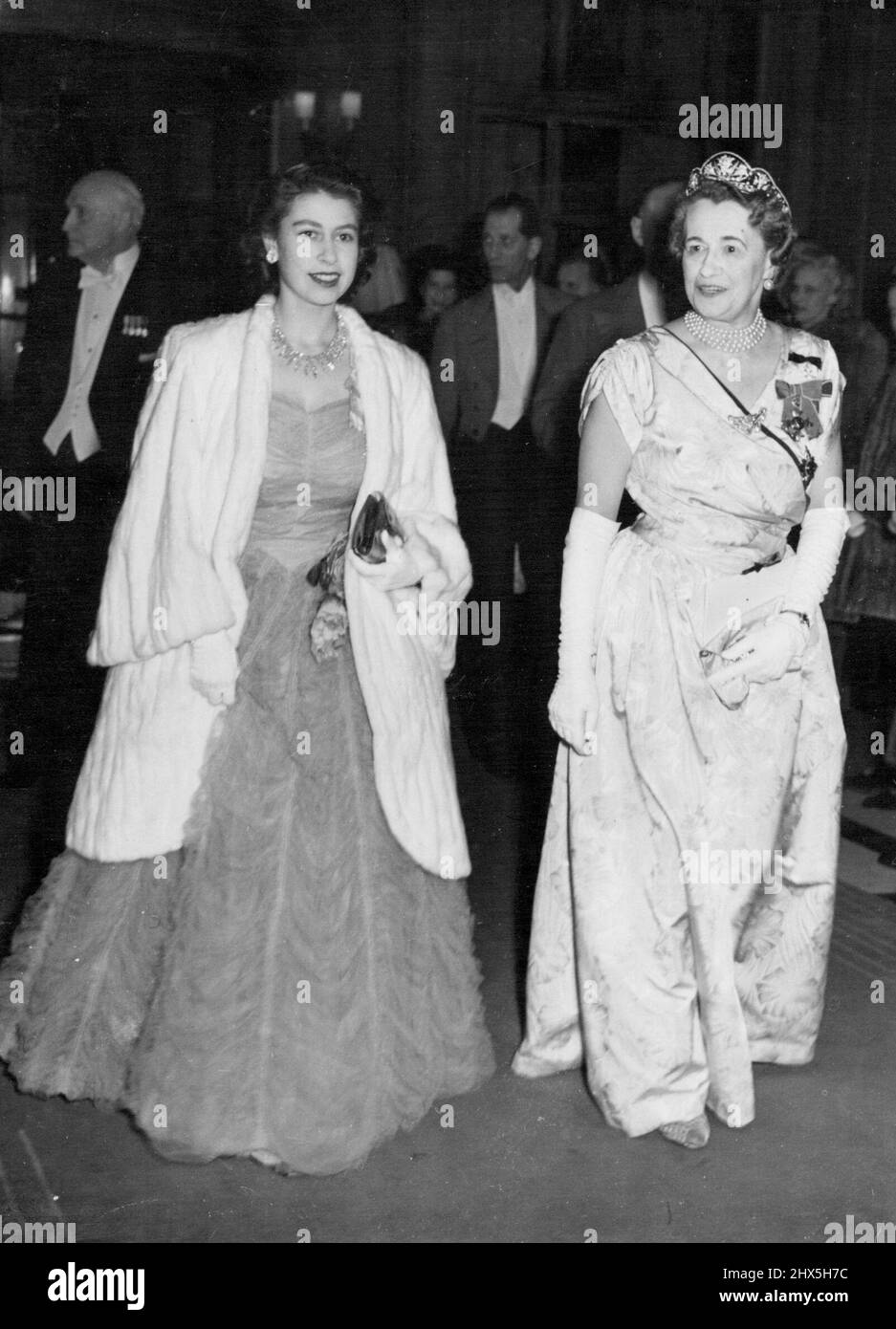 Princess Elizabeth Attends Dinner to Mrs. Roosevelt. Princess Elizabeth (left) arriving for the dinner reception with viscountess Greenwood, wire of the Viscount Greenwood (Chairman of the Memorial Committee of the Pilgrims') at the Savoy Hotel. Mrs Eleanor Roosevelt, who had earlier unveiled the memorial statue to the late President Franklin Delano Roosevelt in Grosvenor Square, was the guest of honour at a dinner given by the Pilgrims' Society at the Savoy Hotel, where tributes were paid the late President. April 13, 1948. Stock Photo