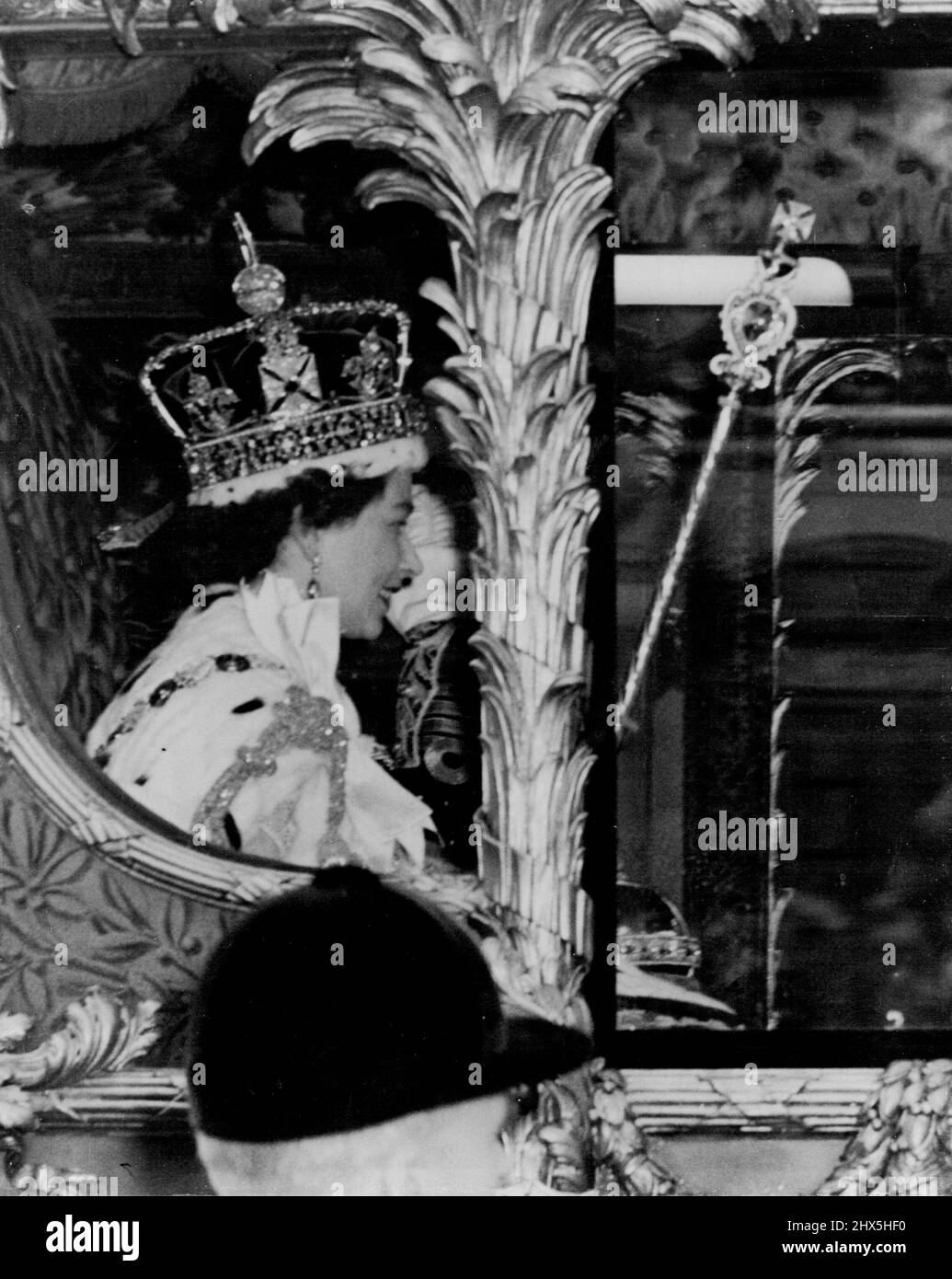The Queen, Crowned, Returns in Triumph To Palace The Queen wears the Imperial State Crown on her had as she acknowledges the cheers from the many thousands who packed the Royal route after her crowning in Westminster abbey. The golden coach in which she is traveling was returning her to Buckingham Palace. The picture was taken in Whitehall. June 02, 1953. Stock Photo