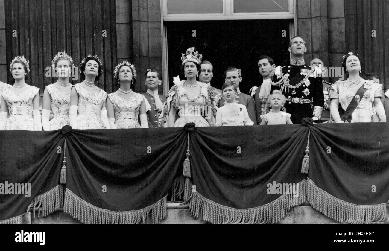 The Royal Family Watch The Fly-Past From The Balcony Of The Palace -- The Queen, wearing the imperial State Crown, Prince Charles, Princess Anne and the Duke of Edinburgh watch the jet planes fly over ahead in Coronation Day tribute to the newly-crowned Queen. Four of the Queens Maids of Honour are on the left (left to right) Lady Jane-Heathcote-Drummond-Willoughby; Lady Anne Coke; Lady Mary Baillie-Hamilton and Lady Jane Vane-Tempest-Stewart. June 02, 1953. (Photo by Press Photos Combine). Stock Photo