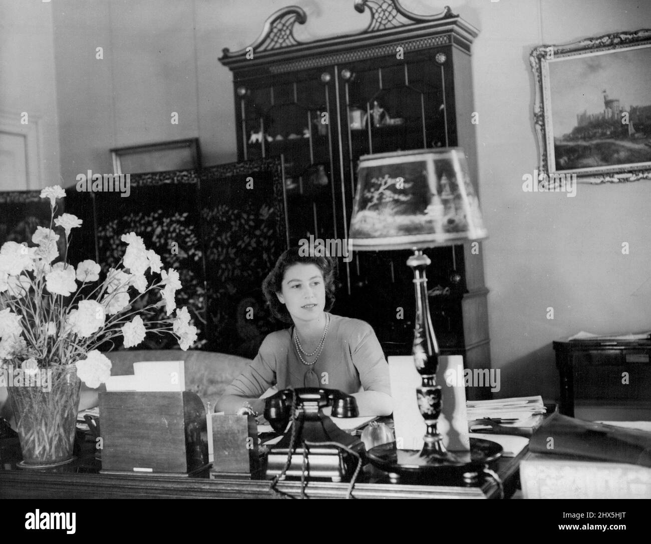 The Queen at her desk in Buckingham Palace. June 16, 1952. Stock Photo