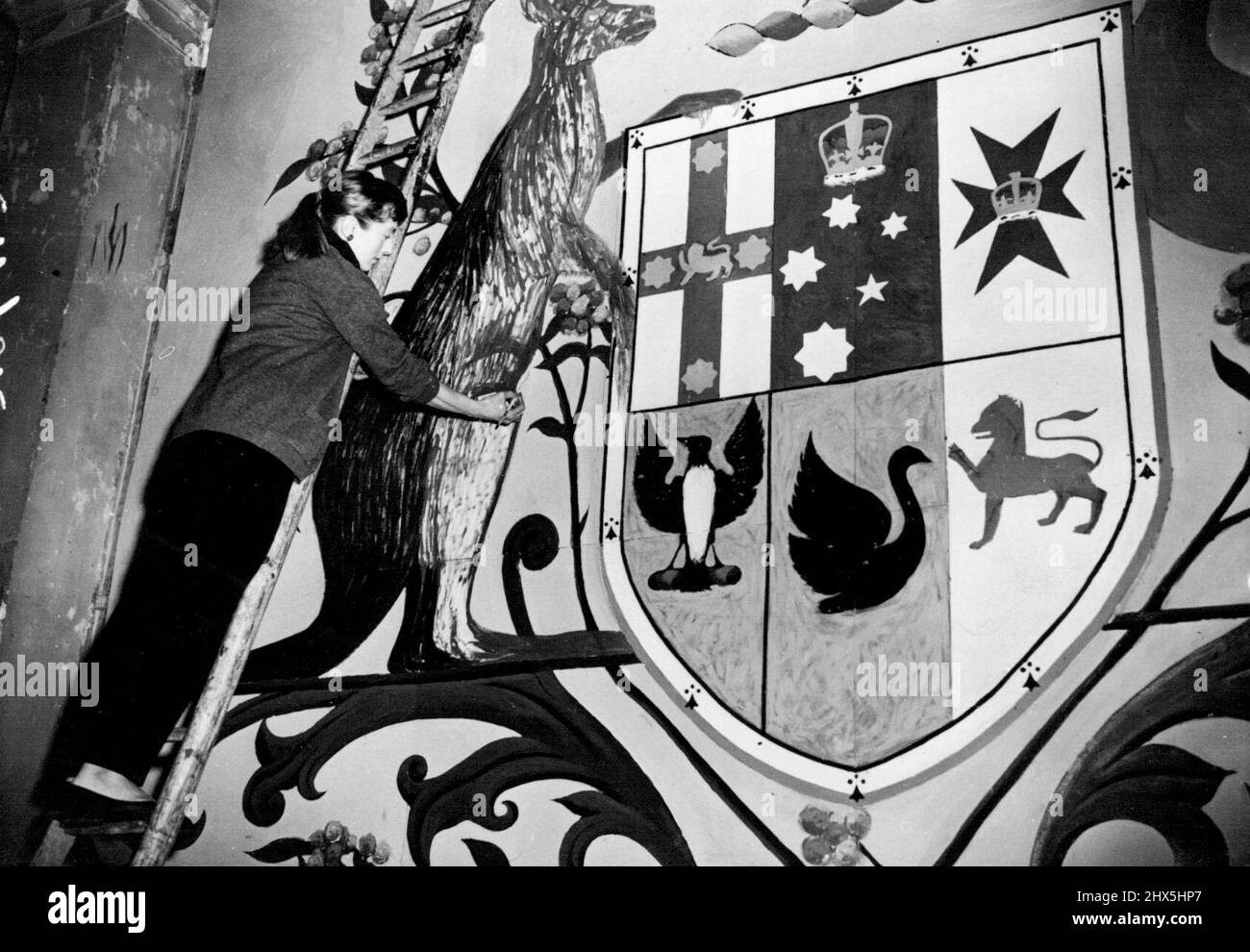 Commonwealth Emblems For The Coronation -- Mrs. Jean Robinson at work on the Australian Emblem. Huge emblems to decorate the great Commonwealth Stand now being erected in Parliament Square for the Coronation now being completed by a team of ***** under the direction of Mr. Kenneth ***** of the Royal College of Arts. April 29, 1953. (Photo by Sport & General Press Agency, Limited). Stock Photo