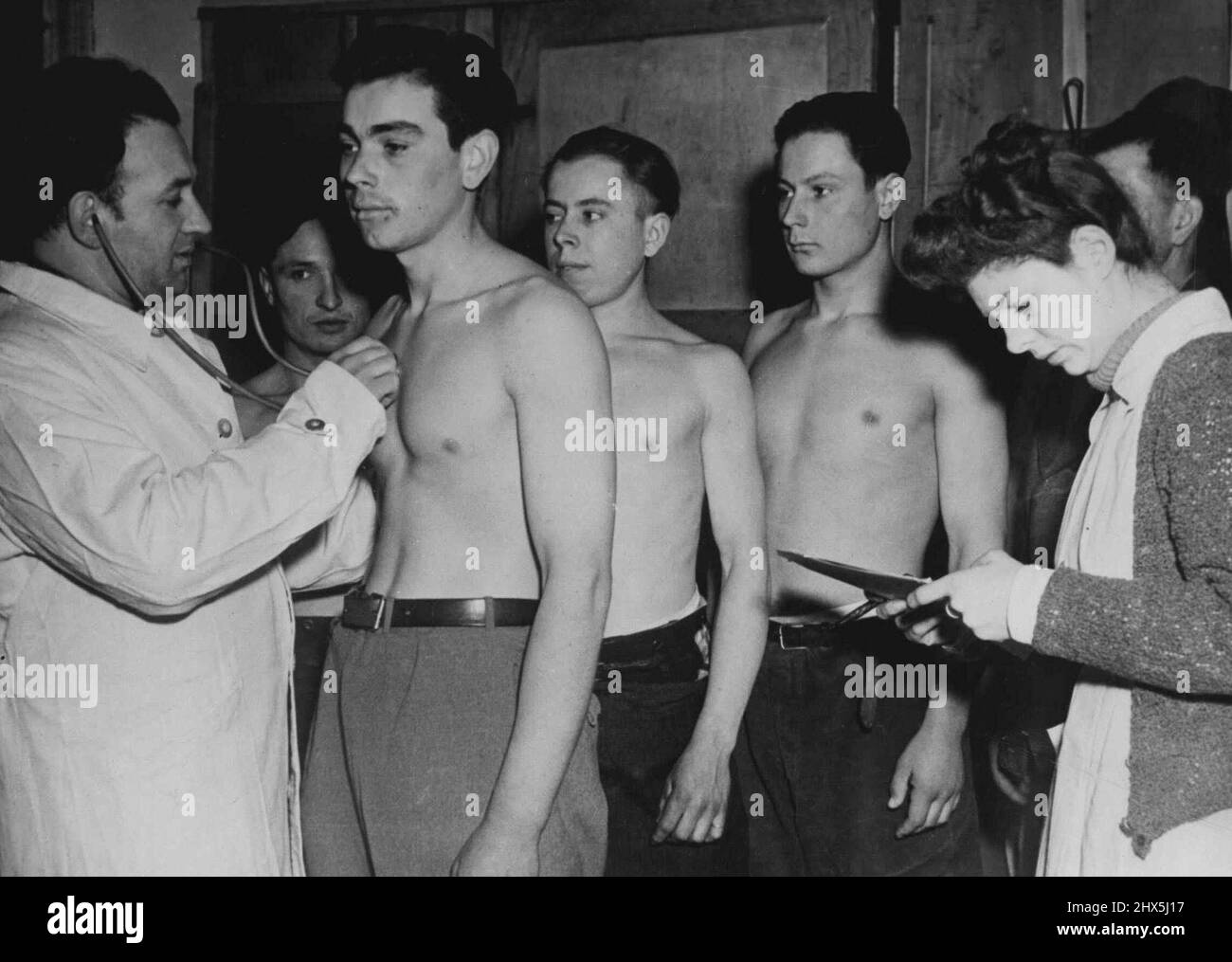Liberated Russians Sheltered In Belgium -- Young Russians workers who had boon serving under the Nazi forced labor system receive a physical checkup from a Belgian doctor March 6, 1945, after being liberated from the Germans by Allied forces. They are under the care of the Belgian Government at an Allied displaced persons center at Namur, Belgium. April 23, 1945. (Photo by U.S. Signal Corps Photo). Stock Photo
