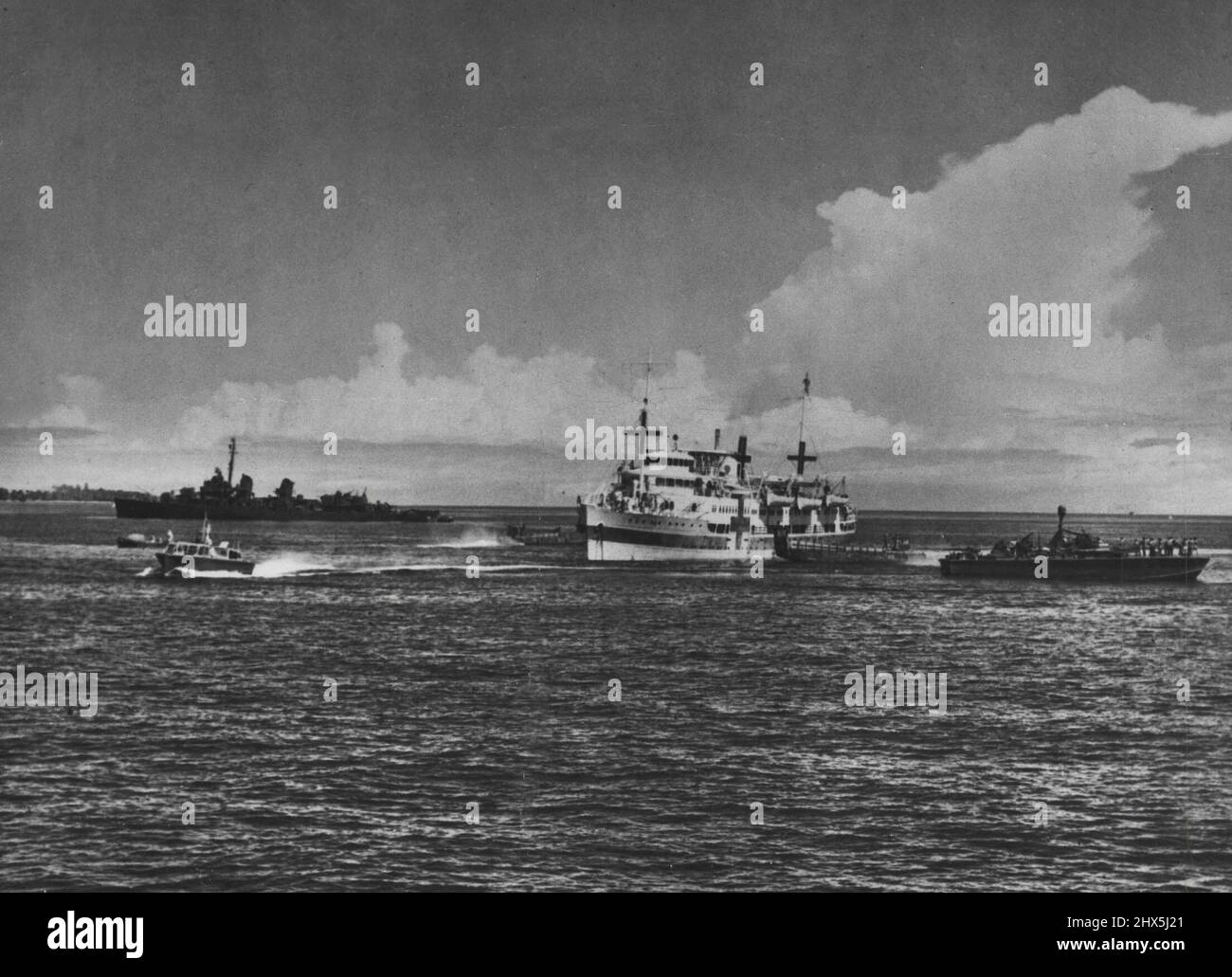 Fake: The Tachihama Maru, fake hospital ship, seen after capture at anchor in an Allied port with the destroyer Conner and a PT boat on guard. August 17, 1945. Stock Photo