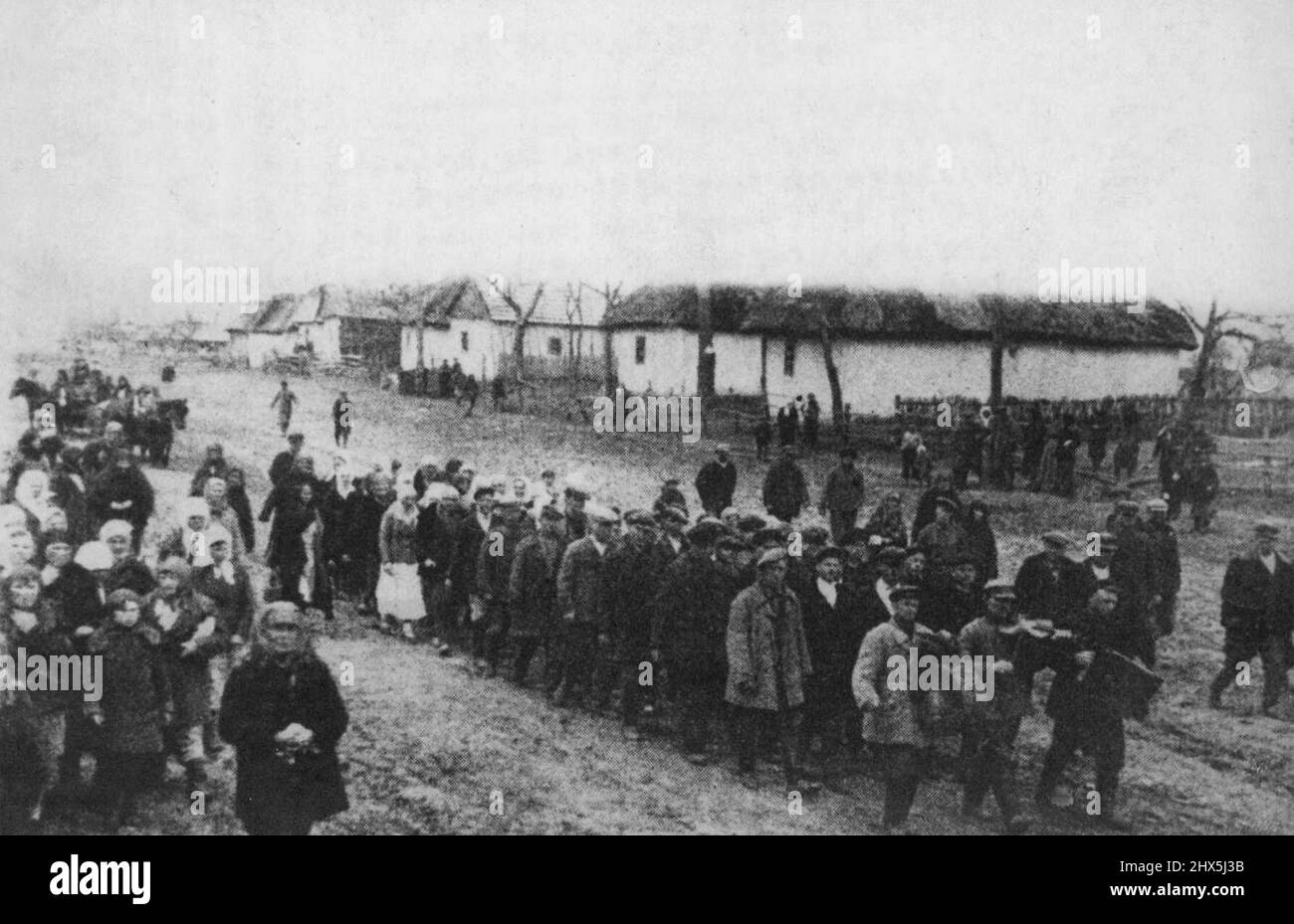 Russians Driven To Slave Labour Camps In Germany -- A sight to be seen in any village in the Nazi occupied territory. which by chance has escaped the maneral destruction and slaughter - all able- bodied men and women are being marched away to work as slaves in German labour camps. For propaganda purposes the Nazis have ordered the village band to head this sad procession. August 10, 1942. (Photo by Keystone). Stock Photo