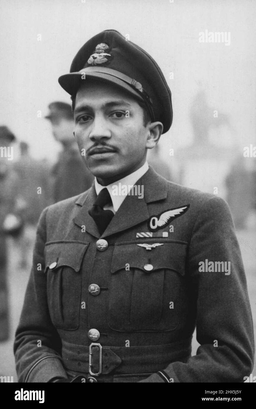 At A Recent Investiture Held by H.M. the Queen -- The Queen deputised for the King at a recent Investiture, on account of His Majesty's indisposition with a attack of influenza. Flying officer S.E. Sukthanker who has made 45 Pathfinder missions over enemy Europe, is the first Indian in the R.A.F. to be decorated with the D.F.C. he received this award from Her Majesty the Queen. December 9, 1943. Stock Photo