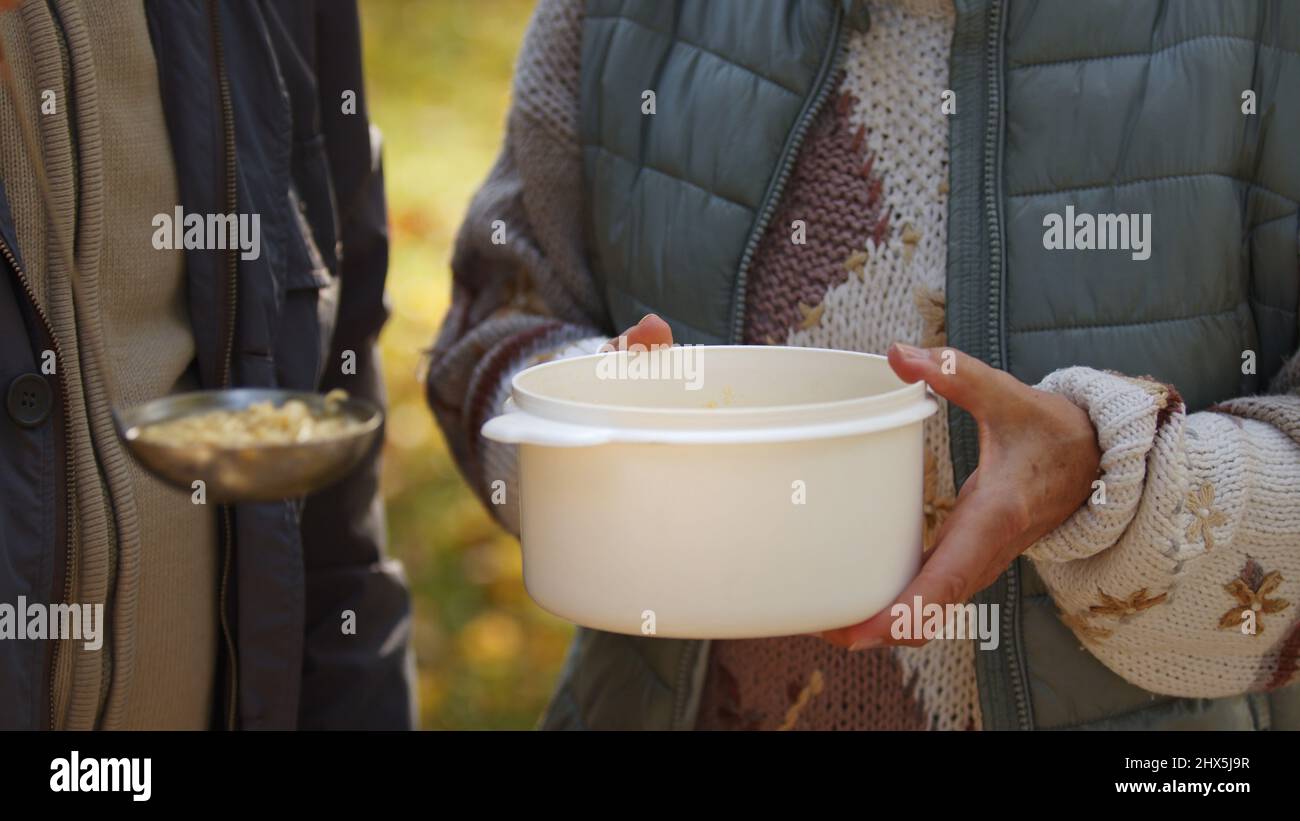 Showing support to homeless people in need by volunteering and giving ...