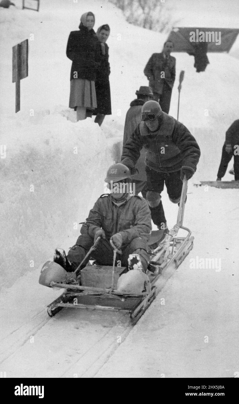 Olympic Games in Switzerland. Going down : Squadron Leader Jeffery and Wing Commander Iremonger, members of the English bob-sleigh team, taking off for a practice run at St. Moritz. January 30, 1948. (Photo by Sport & General Press Agency, Limited). Stock Photo