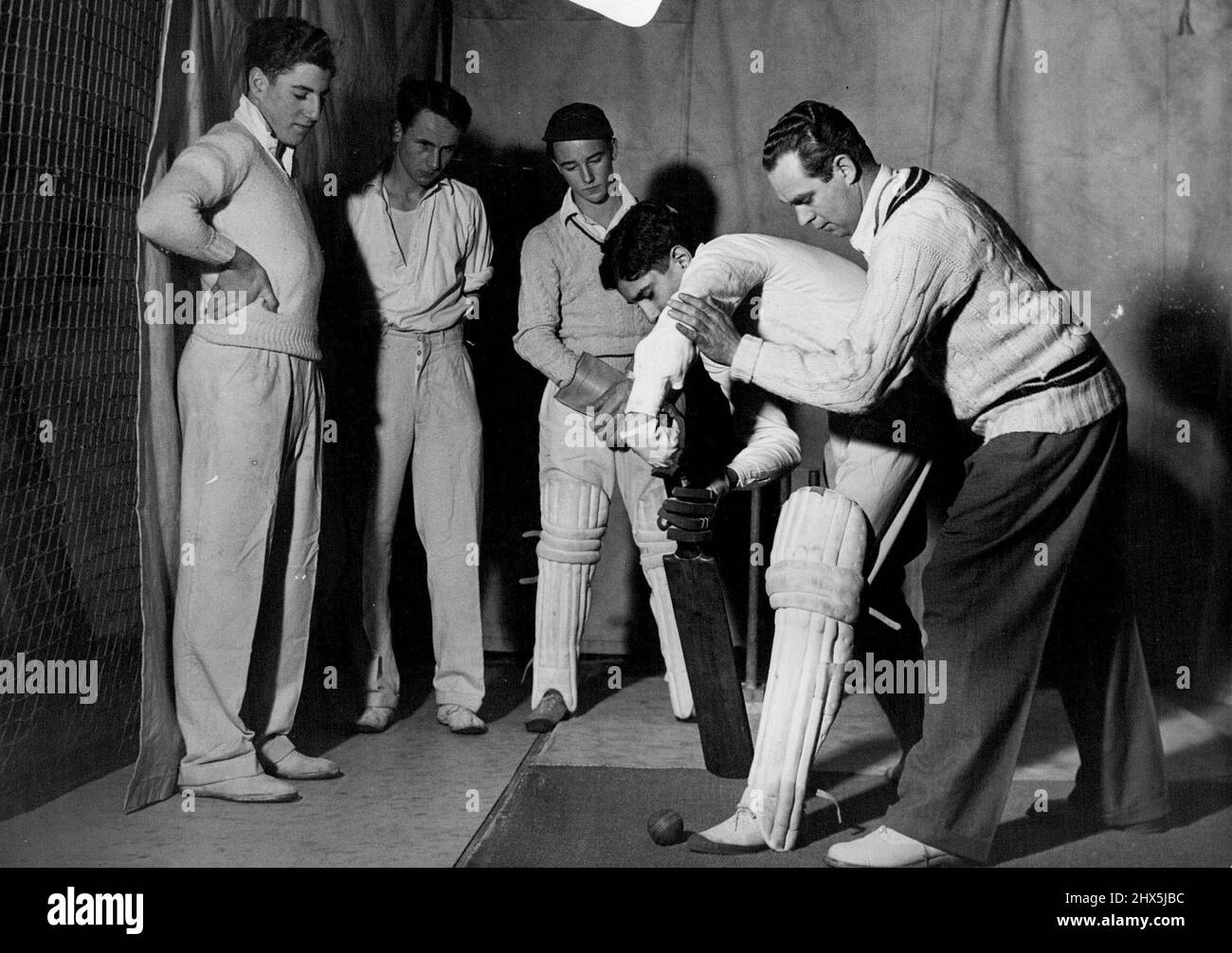 Middlesex Coaches Young Cricket Talent -- K. Bonerji, of Dulwich college and Unites Provinces of India, at the nets at the school. His instructor is Alec Thompson, the Middlesex country player. Middlesex Country cricket club have a winter coaching scheme for boy cricketers which is probably the first of its kind. Selected talented players from 36 schools in the country are being coached at the Chiswick indoor cricket school by most of their ***** holiday's by getting in as much practical coaching as possible. January 01, 1948. (Photo by Fox Photos). Stock Photo