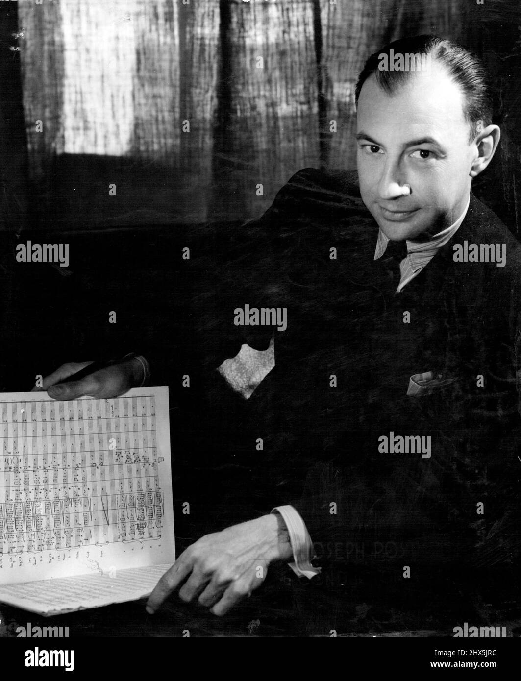 Joseph Post deputy conductor of the Sydney Symphony Orchestra, conducts tonight. (Tuesday). The orchestra is to play Beethoven's Symphony No. 4, and the Strauss Symphonic Poem -- Tod and Verklarung, at 9-15 p.m. from 2BL-2NC. November 22, 1948. Stock Photo