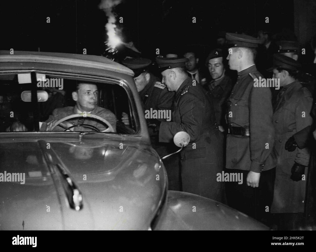 'All Clear' From The Russians as Blockade Is Lifted -- Russian officers check one of the first American cars to cross the border at Helmstedt soon after the blockade was lifted at Midnight May 11/12. The Russians delayed the driver for only a few minutes while they checked his papers and then waved him on his way to Berlin. May 12, 1949. (Photo by Associated Press Photo). Stock Photo