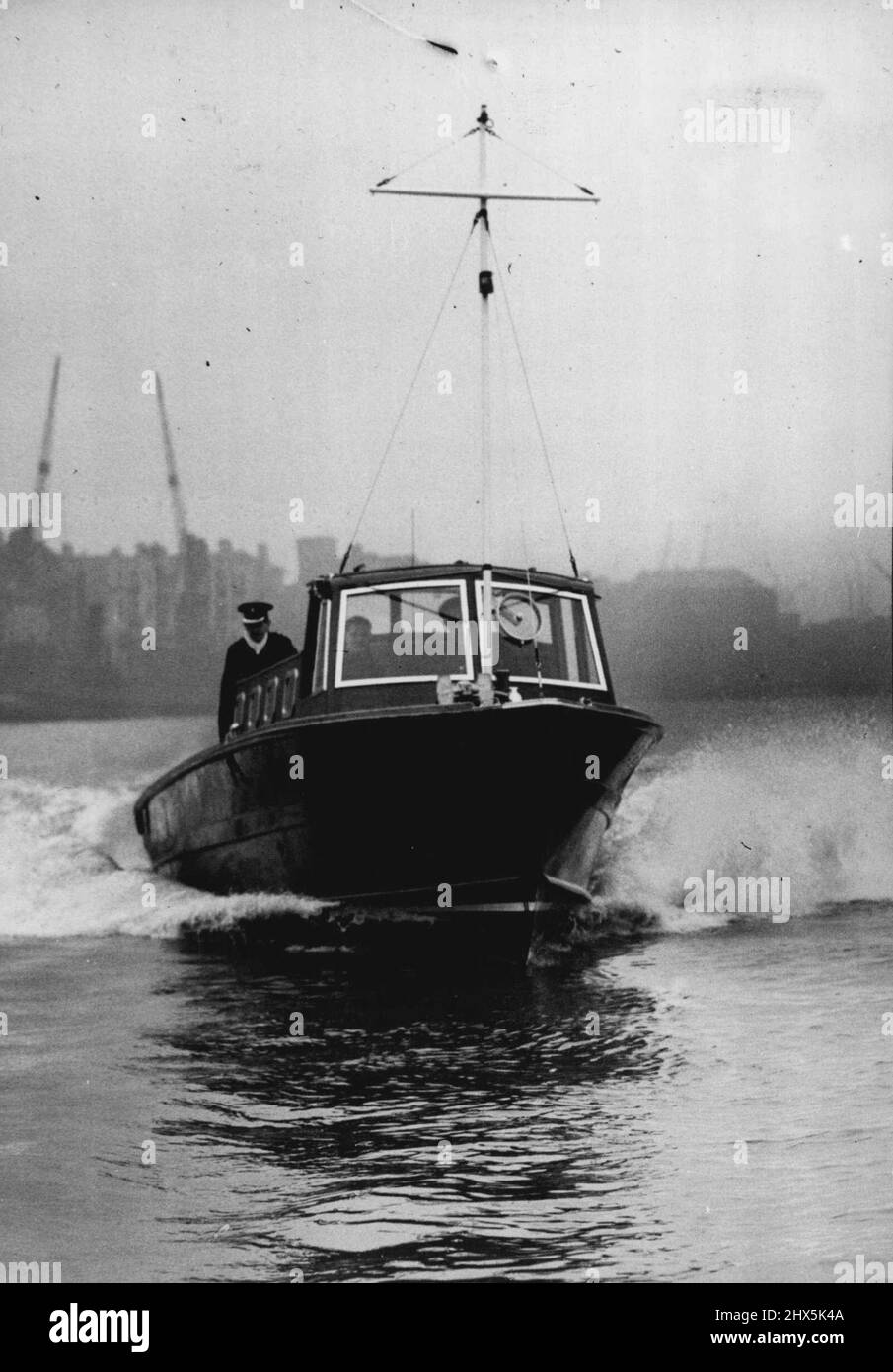 River Police Get Fast New Boats From The R.A.F. One of the new Thames River Police craft traveling at high speed during a trial run on the River Thames, London. The first of three new high-speed craft for the Thames River Police has been launched of the River Thames in London. The boats are forty-feet long ex-Roayl Air Force seaplane tenders adapted for their new role. Each is Fitted with two 100-horsepower Diesel engines, and twin screws - giving a speed of twenty-two knots and is equipped with two-way radio and searchlight. March 14, 1947. Stock Photo