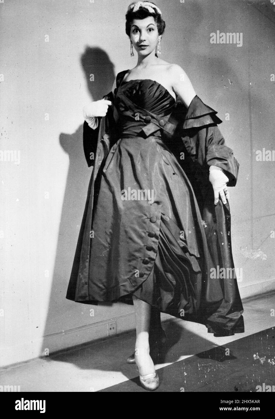Paris Spring Fashions : 'Compliment,' an ensemble by Maggy Rouff. It is a cocktail dress in navy blue faille. Coat of the same material. February 24, 1955. Stock Photo