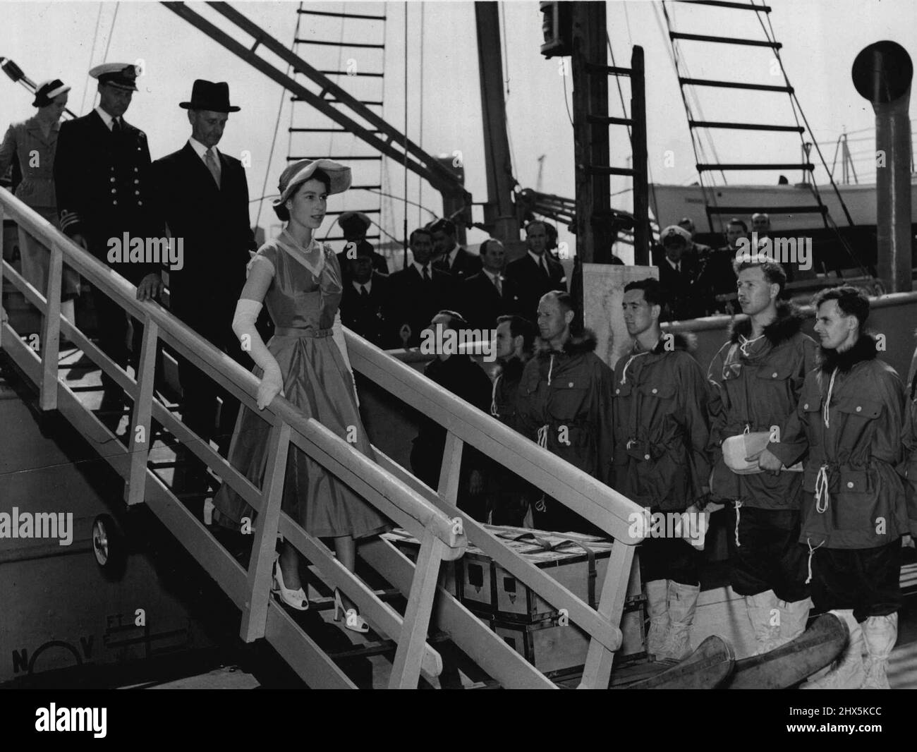 The Norwegian sealer Tottan, which has been chartered for British expedition to Greenland was inspected by H.M. The Queen at Tower Pier yesterday. The Queen inspects the men on the Tottan. They all wore Middle-Parka jackets over a combat suit with Mukluk boots. July 02, 1952. (Photo by Daily Mirror). Stock Photo