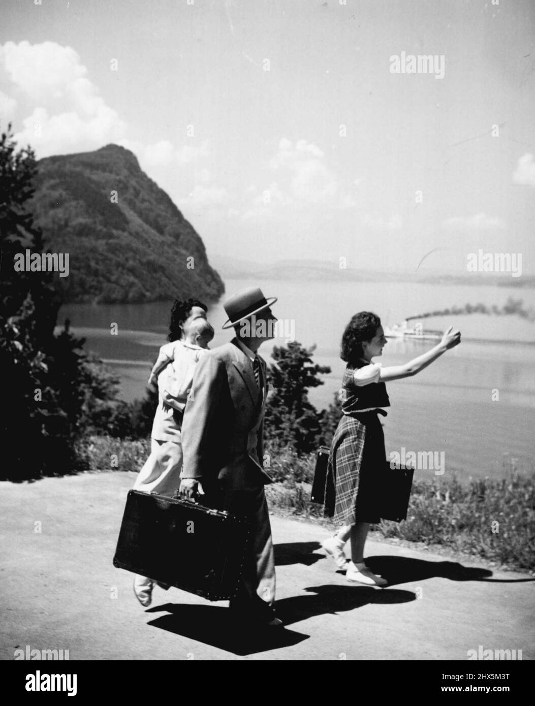 Swiss Labor Holiday (4) of Seven: At Lucerne the maeders transferred to a boat which took them to the resort village of Vitznau. They are on their way to the Swiss Metal and watchmakers Union holiday house. Railways and boat lines give the workers half fare during the vacation period. September 03, 1948. (Photo by ACME Photo). Stock Photo