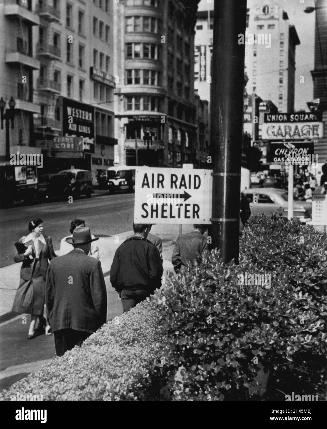 Air Raid Shelter Signs Go Up -- For the first time since World War II air raid shelter signs were posted in San Francisco today. This sign is posted on the Geary street entrance to an underground garage built four stories below San Francisco's historical Union square. June 06, 1951. (Photo by AP Wirephoto). Stock Photo