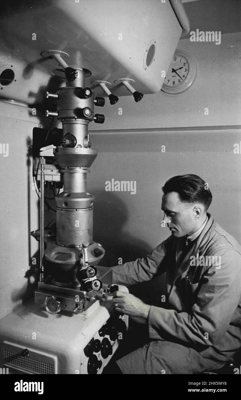 A research worker operating a modern electron microscope. Latest tool of the research worker, the electron microscope, uses a beam of electrons instead of light, to examine tiny objects. The glass lenses of the ordinary microscope have their equivalent in the 'electric' lenses which focus the electrons. November 10, 1950. Stock Photo