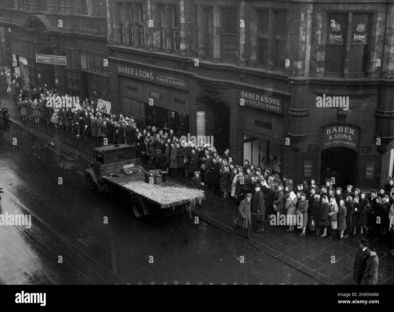 Industrial Switch-Odd Stakes Workless ***** -- Workers queuing up outside an Employment Exchange in Manchester following the great industrial switch-off by which millions have been thrown out of work. It is estimated about 6,000,000 workers will be effected. This is about half the insured working population of this country and presents the Government with new problems especially with regard to unemployment benefit. February 12, 1947. (Photo by Mirror Features). Stock Photo