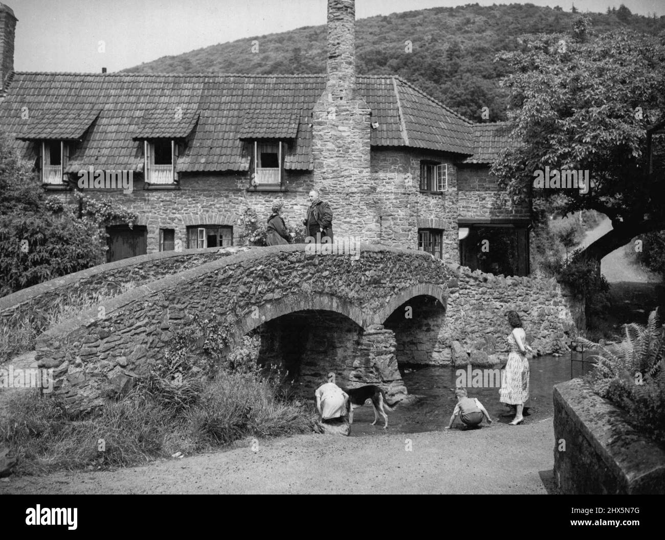 Ancient Britain -- Quaint and picturesque survival from a leisurely age - the ancient hump-back Pack Horse Bridge at Allerford in Somerset. June 21, 1955. (Photo by Reuterphoto). Stock Photo