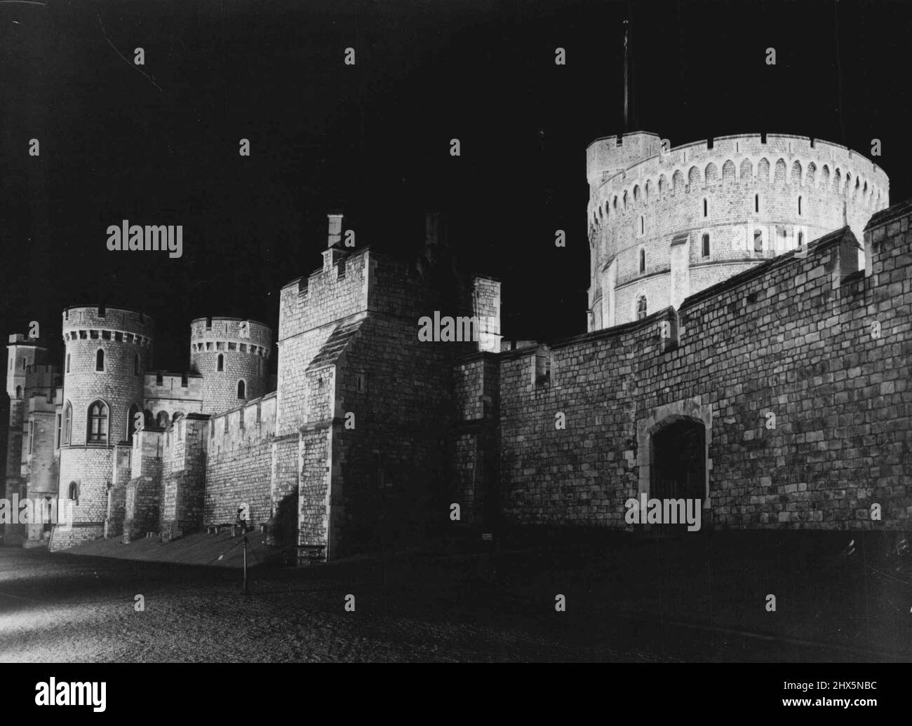 Windsor Castle By Floodlight -- Historic Windsor Castle makes an impressive picture with shadows cast on the walls and turrets during a floodlighting test for the Festival of Britain. April 30, 1951. Stock Photo