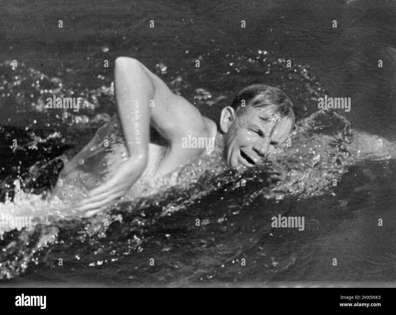 State 880yd champion Noel Ryan (Wagga) turns on the face in a practice swim at *****. December 20, 1946. Stock Photo