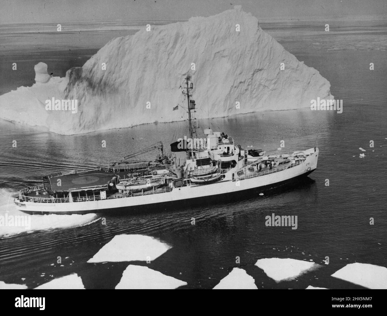 Greenland Cosmic Ray Scientific Expedition By The U.S. Office of Naval Research -- During the summer months of August and September 1952, the U.S. Office of Navel Research carried out a series of high altitude cosmic ray investigations in the vicinity of the *****. The United States Coastguard cutter 'Eastwind' with its 'postage stamp' flight deck (60 feet in diameter) from which balloons measuring up to 180 feet were launched, nosing bar way through the ice in the region where the balloons ware sent up. November 20, 1952. Stock Photo