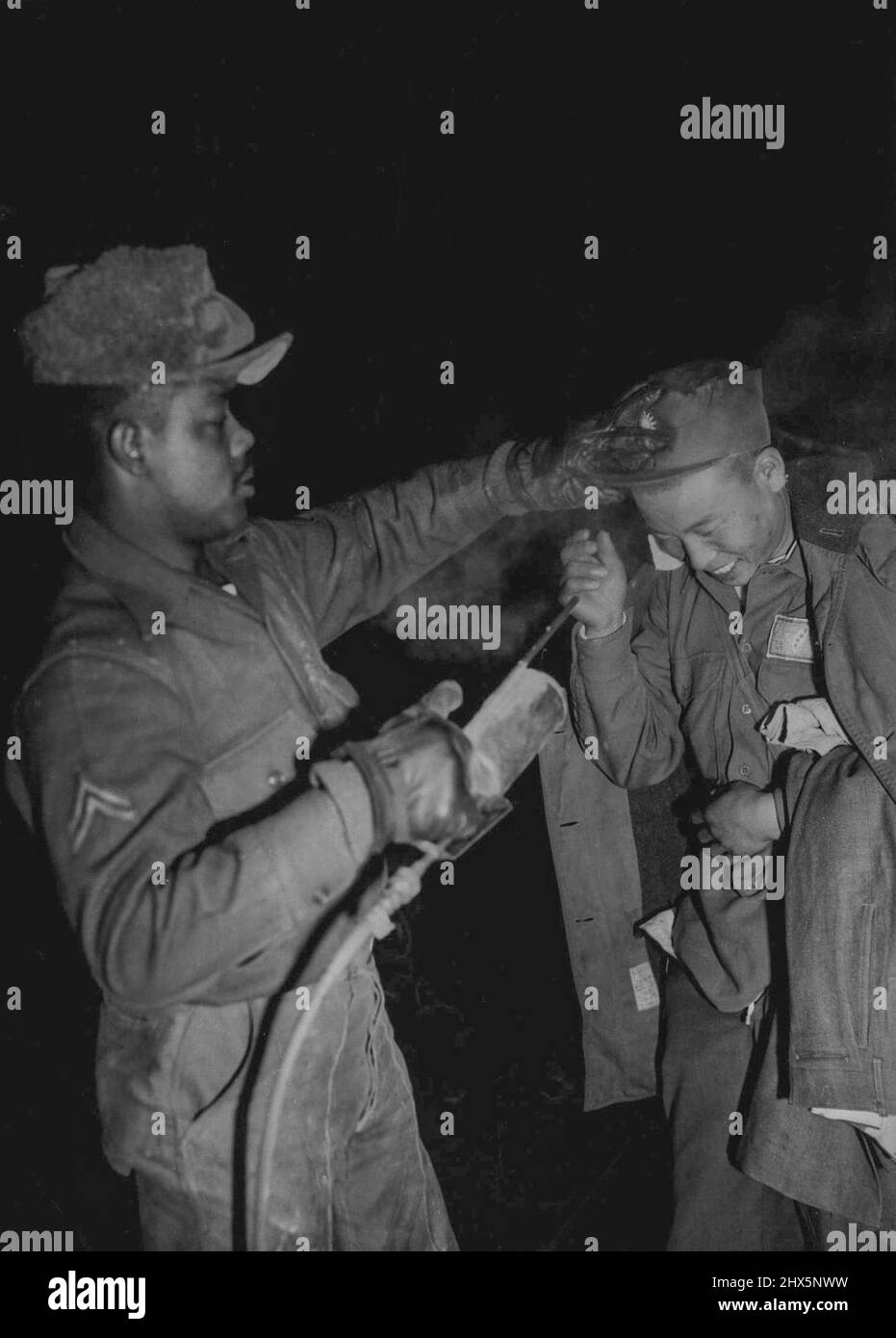 Korea Pows en Route to Chiang Kai-Shek -- A freed Chinese Laughs as he gets a routine de-lousing spray at Ascom City before moving on to inchon and Formosa. Following the release of Nearly 22,000 Chinese and North Korean prisoners of war by their Indian custodians, Thousands of Chinese have been streaming to inchon to Board tank-landing shops which will take them to Formosa. American warships and planes will Escort them to the Nationalist China island ruled by Chiang Kai-Shek. The trip will take three days. January 26, 1954. (Photo by Associated Press Photo). Stock Photo