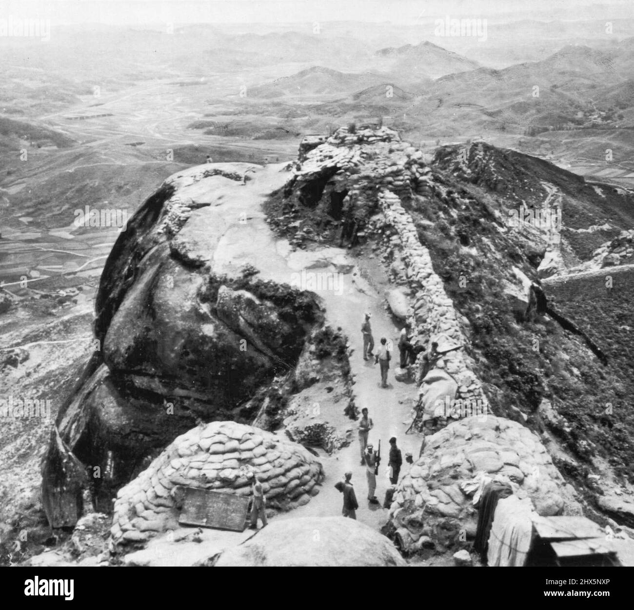 One of Front lines in Korean Dispute -- South Korean troops man a lookout post in rugged mountainous terrain along the 38th parallel dividing line between South and North Korea. Communists control the territory in right background and the valley which follows a winding course in center distance. Territory at left is controlled by South Korea. Today Communist troops invaded South Korea on a wide front and U.S. military advisers said the Northerners pushed three miles south of the border at one point before they ran into first determined resistance. June 24, 1950. (Photo by AP Wirephoto). Stock Photo