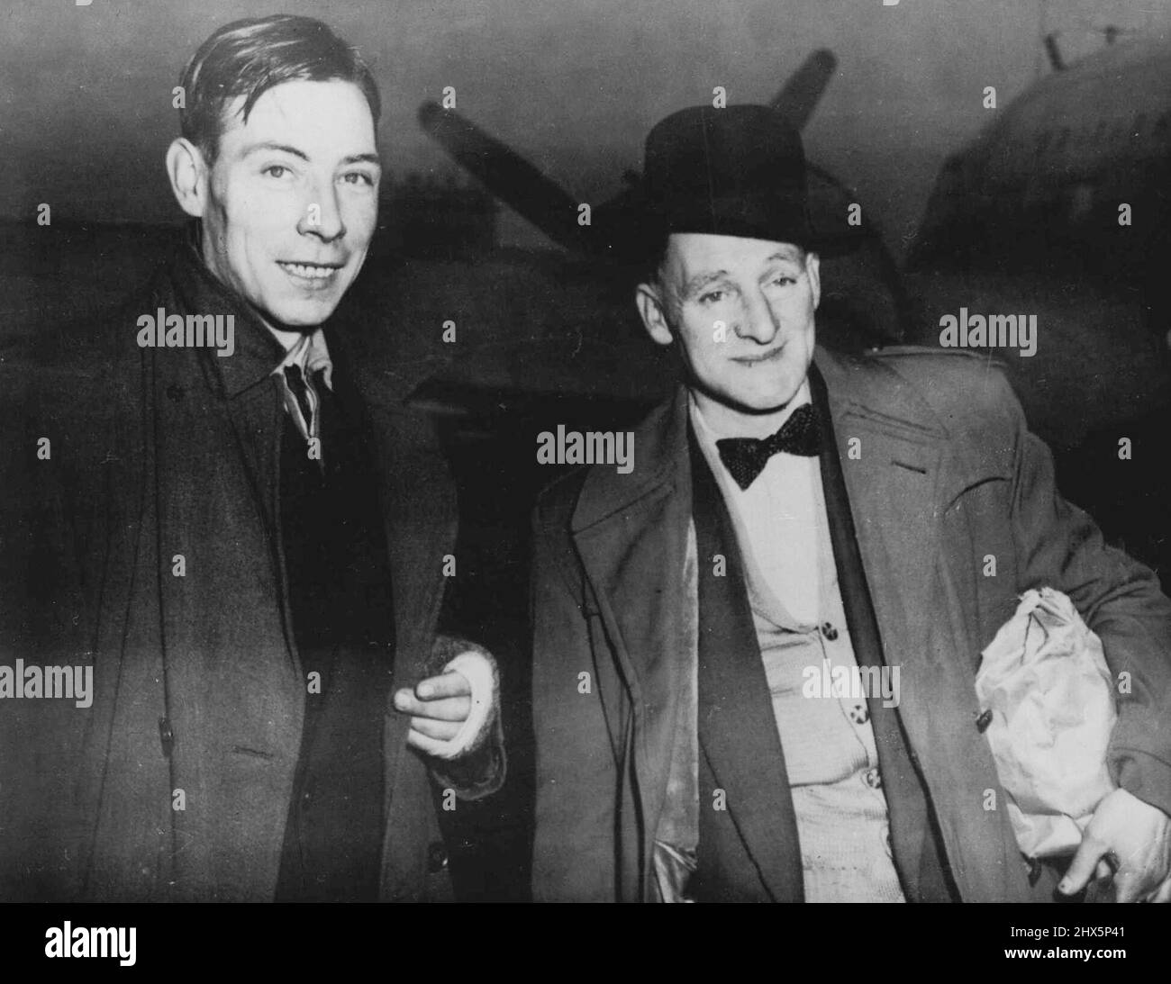 Londoners Fly To German 'Slave Labour' Test Case R.W. Ferris (left) and Charles C.J. Coward, Both of London and former prisoners of war in Germany, arrive by air in Frankfurt today February 18. They are to give evidence in a claim by a former 'Slave Labourer' against the I.G. Farben Combine. It is a test case for more than 100 other former 'Slaves.' Coward and Ferris are to speak for a former concentration camp inmate, Norbert Wolheim, now living in USA, who claims £833 as wages for work in the Buna-Monowitz syn synthetic rubber plane, near Auschwitz, during the war. February 18, 1953. (Photo Stock Photo