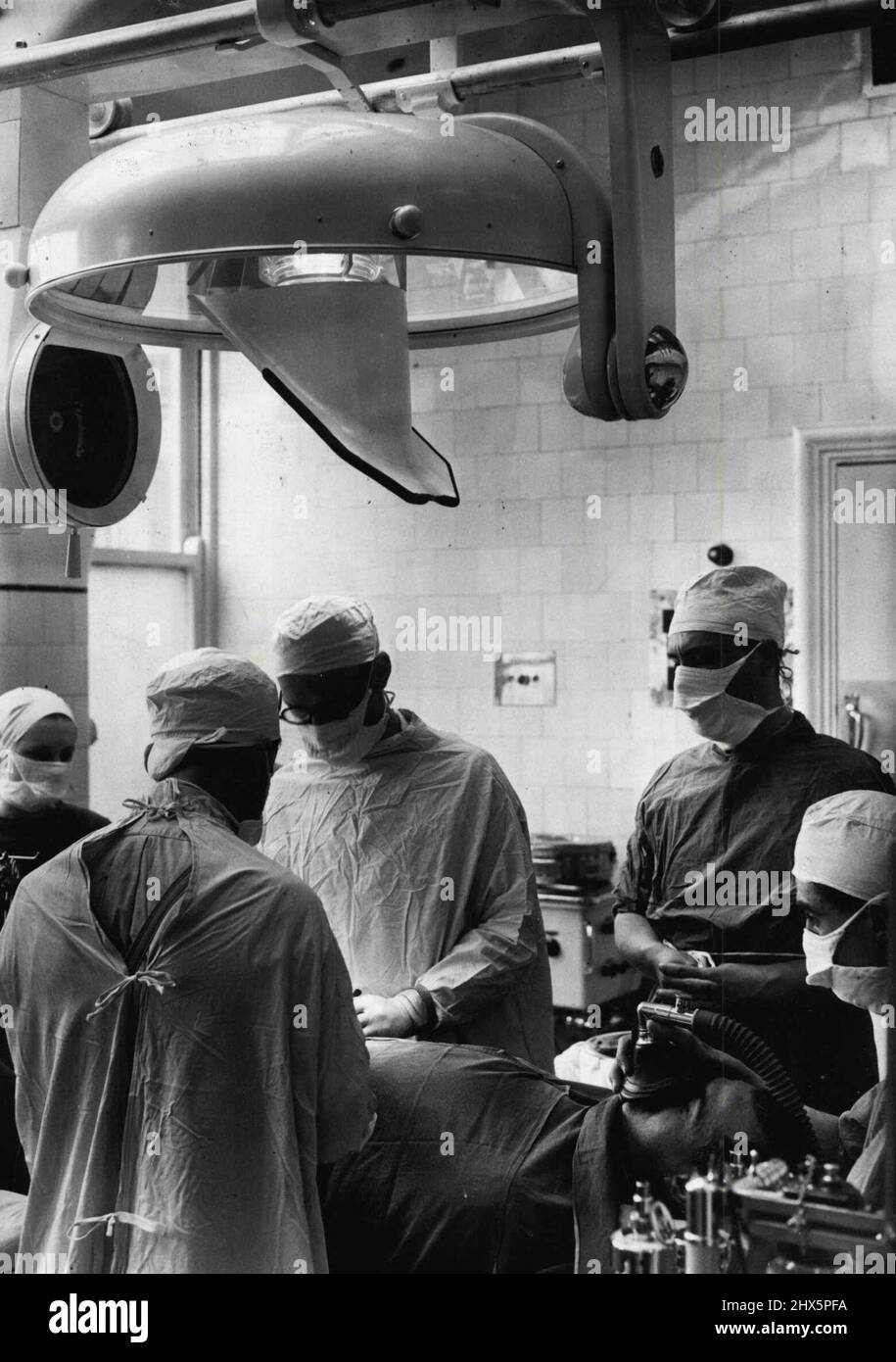 Television Aids The Surgical, Students -- The television cameras above the operating table during the operation at Guys Hospital, London, today. Students of surgery at Guys Hospital, London, can ***** get a close-up view of the skilled hands of a ***** performing the most intricate operations a they sit comfortably around a television screen, and can see every detail. This development in the study of surgery is one of the most important for years. The television camera is poised immediately above the surgeon as he works, and the student sees every movement as he works. May 11, 1949. (Photo by Stock Photo