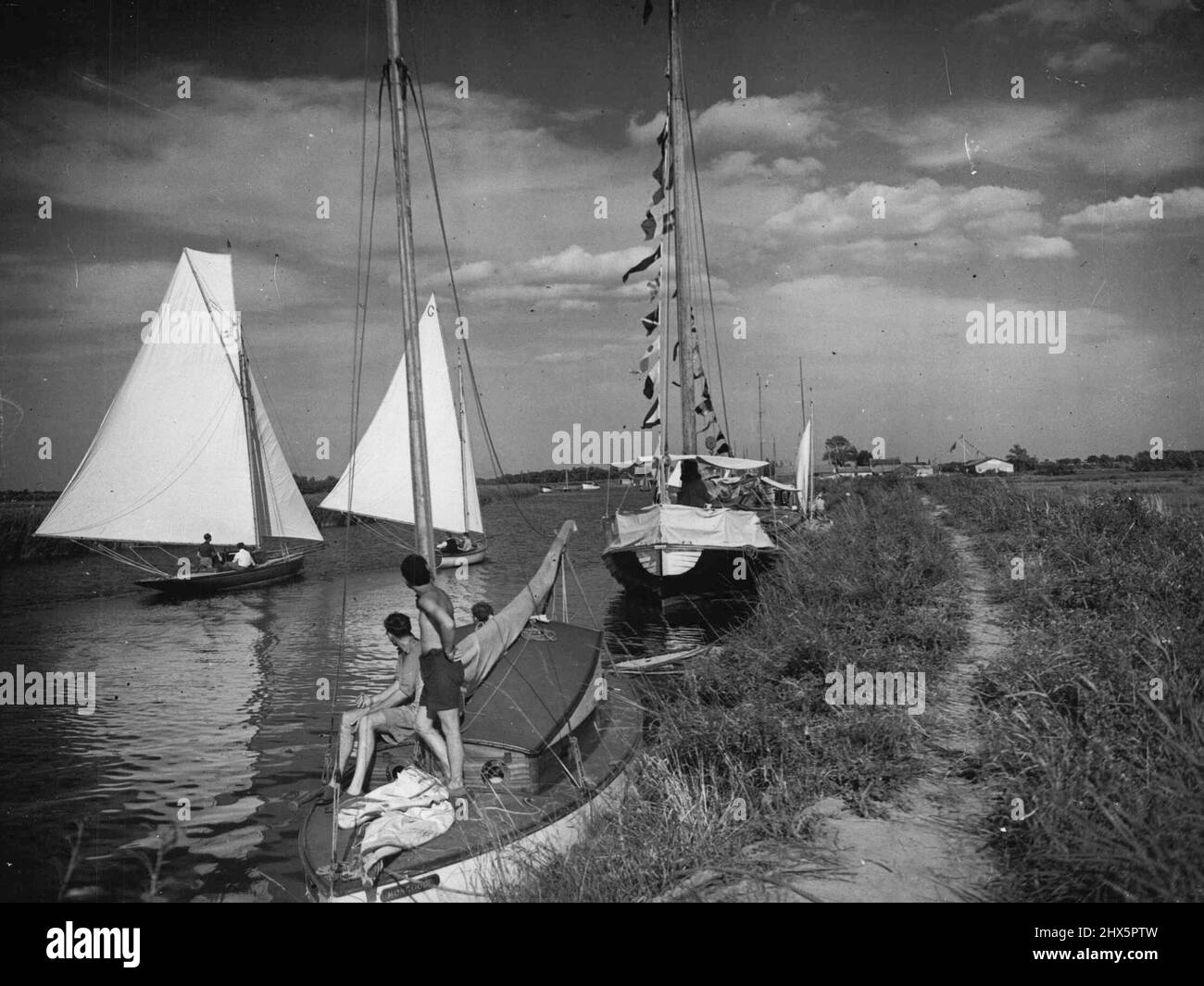 Holiday Joys On The Borads -- Despite the rush to the Continent for holiday this year, yachting on the Norflok Broads is still the most popular 'holiday at home'. July 30, 1946. (Photo by Mirror Features). Stock Photo