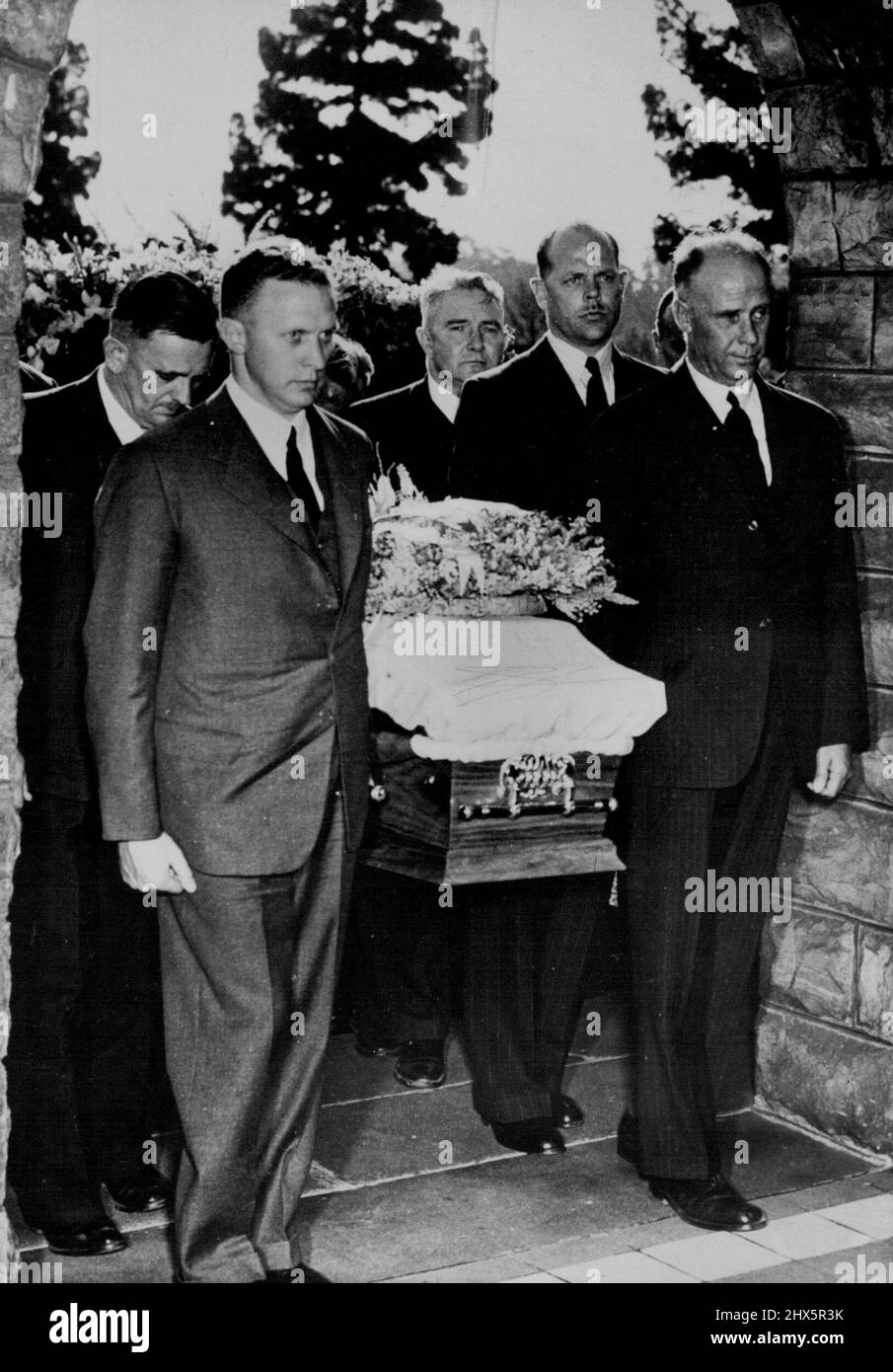 Funeral Of General Smuts -- The coffin of Field Marshall J.C. Smuts is carried into the crematorium. The pallbearer on the right of the picture is J.C. Smuts Junr, the son of General Smuts. The other people are family members. September 21, 1950. (Photo by Fox Photos). Stock Photo