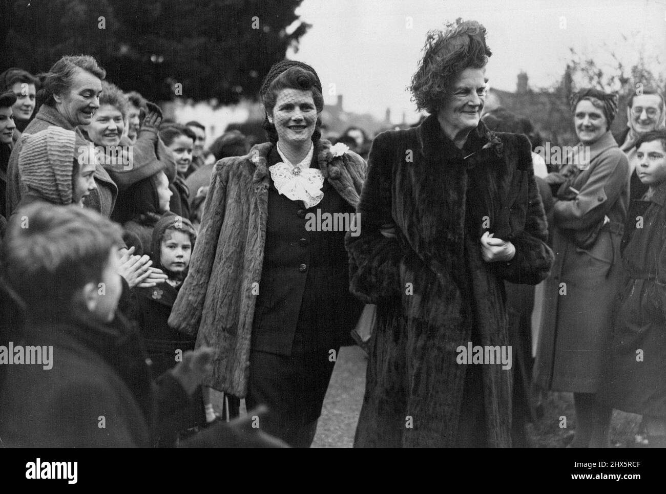 Lord Woolton's Son Weds -- Miss Mary Churchill, whose engagement to Capt. Christopher Soames was announced yesterday, gets a big hand from sight-seers as she arrives with her mother for the wedding at Beaconsfield to-day (Saturday). At the Church of St. Mary and All Saints, Beaconsfield, Bucksm this afternoon (Saturday), the Hon. Roger David Marquis, son and heir of Lord Woolton, was married to the Hon. Lucia Lawson, only daughter of Major General Lord Burnham, of Hall Barn, Beaconsfield. The bridegroom's father is a former Minister of Food and Minister of Reconstruction, and was recently Stock Photo