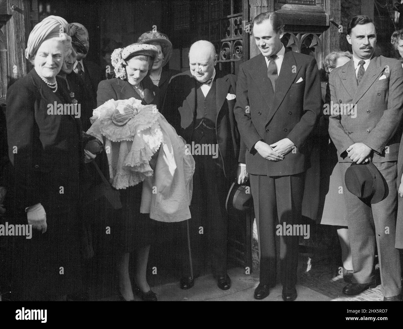 Christening of Arthur Nicholas Winston Soames, son of Captain and Mrs. Soames and the youngest grandchild of Mr. Winston Churchill at the Westerham Parish Church, Kent. Left to Right: Mrs. Churchill, Mrs. Christopher Soames, holding her infant son, Mr. Churchill and Captain Christopher Soames, father of the child, outside the Church after the ceremony. January 01, 1948. (Photo by Sport & General Press Agency, Limited). Stock Photo
