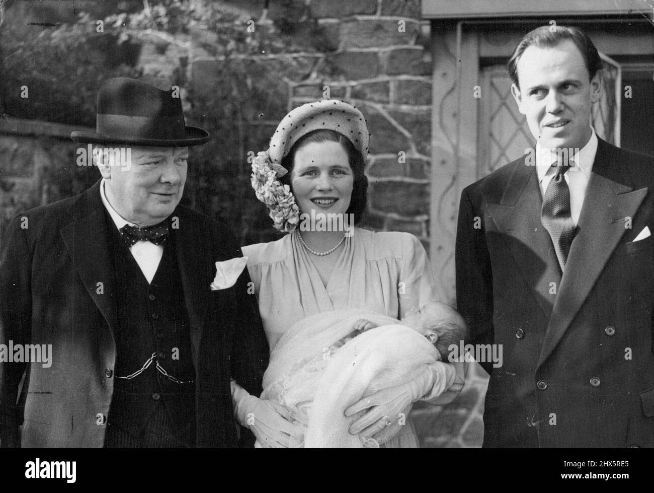 Churchill's Fifth Grandchild Christening -- Captain and Mrs. Christopher Soames, Mr. Winston Churchill and newly-christened Arthur Nicholas Winston Soames pictured at the Christening party which followed the service at Westerham to-day. (Sunday). Mr. and Mrs. Winston Churchill were present at Westerham Church, Kent, to-day (Easter Sunday) for the christening of their grandchild, Arthur Nicholas Winston Soames, first child of their daughter Mary, who in February 1947 was married to Captain Christopher Soames. March 28, 1948. (Photo by Reuterphoto). Stock Photo