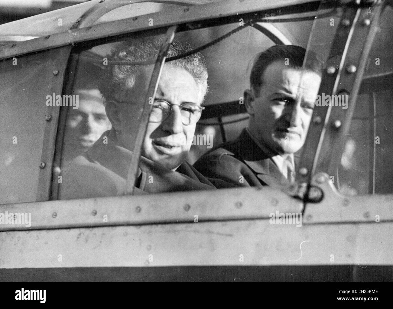 Smertenko Leaves Croydon After Night At Police Station - Professor Smertenko takes a last look at Croydon from the cabin of the plane as he departs. Having spent the night in Wallington Police station, Surrey, Professor Johan Smertenko, 50-year-old Vice-President of the American League for a Free Palestine left Croydon Aerodrome, near London, to return to Paris. He flew in the same private-charter French plane in which he had come to Britain in difiance of a Home Office ban on his entry. The ban had been imposed following Smertenko's visit last December, when he had accused Britain of Stock Photo