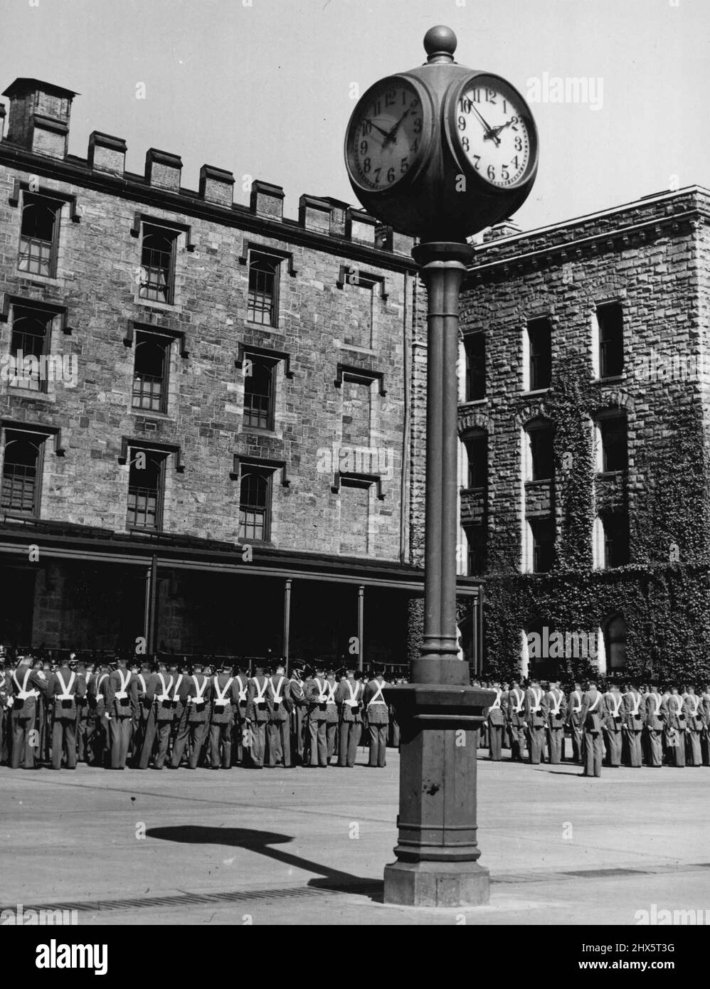 West Point Hub -- Literally and figuratively, life at West Point revolves around this clock in the barracks area. From here, buglers blow the various calls of the day and night. On week days, 'Lights out' is at Ten O' clock. January 11, 1940. (Photo by Acme Photo). Stock Photo