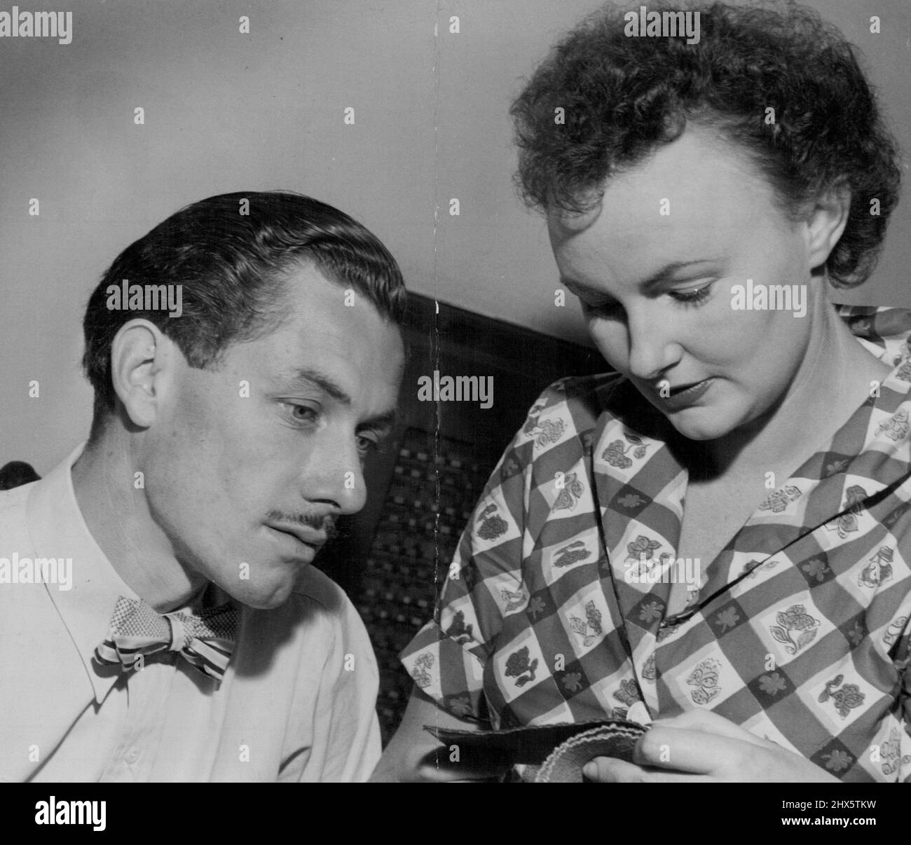 In Sydney with his wife. They are examining fabrics suitable for using