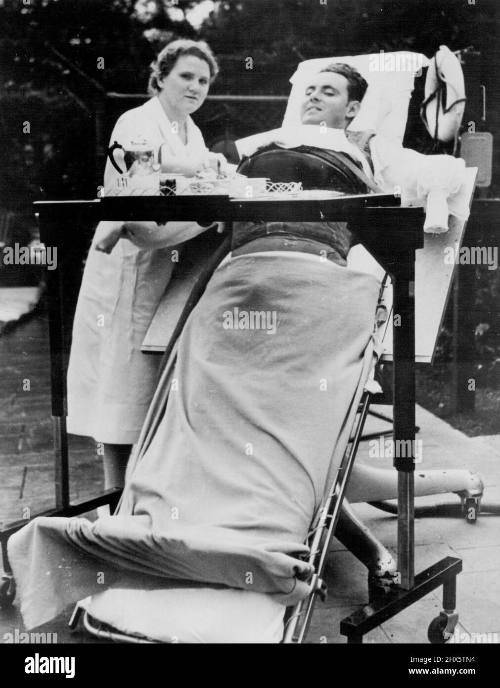 Snite Now Uses 'Vest Lung' - Frederick B. Snite, Chicago Financier's son who has been paralyzed by infantile paralysis for more than two years, in the New lightweight 'Vest Lung' which fits over the chest alone, that has replaced the 'Iron Lung' in which he was brought home from China, where he was stricken. He leaves Chicago Oct. 25 for the family home in Florida to spend the winter. October 25, 1938. (Photo by Acme). Stock Photo