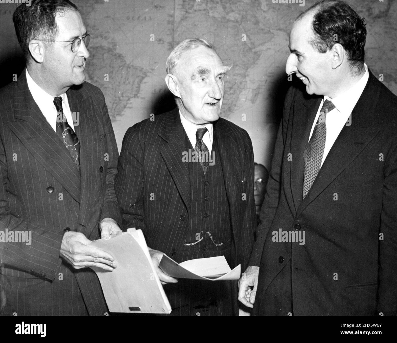 At Food Council Meeting - Left to right: Clinton P. Anderson, U.S.; Sir John Boyd Orr, representing the food and agriculture organization of the U.N.; and Sir John Strachey, British food minister, attend the opening meeting of the International emergency food council in Washington, D.C., June 20. June 21, 1946. (Photo by Associated Press Photo). Stock Photo