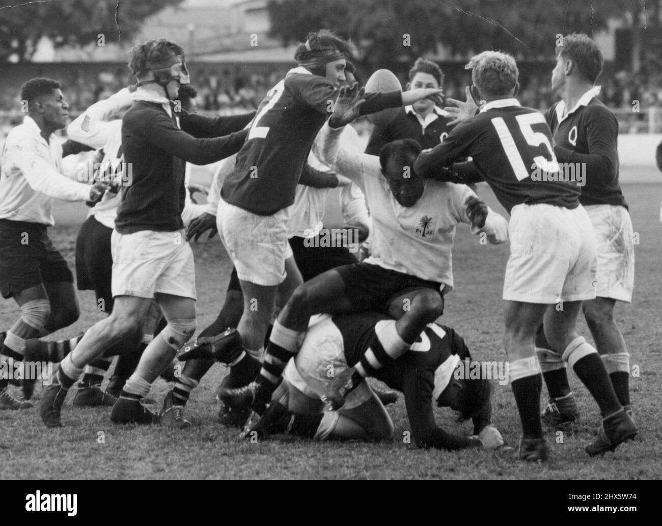 Fijian Captain Tuitava sip on Queensland forward O'Brien in a saaammage for the ball. May 29, 1954. (Photo by The Telegraph Newspaper Co.Ltd.) Stock Photo