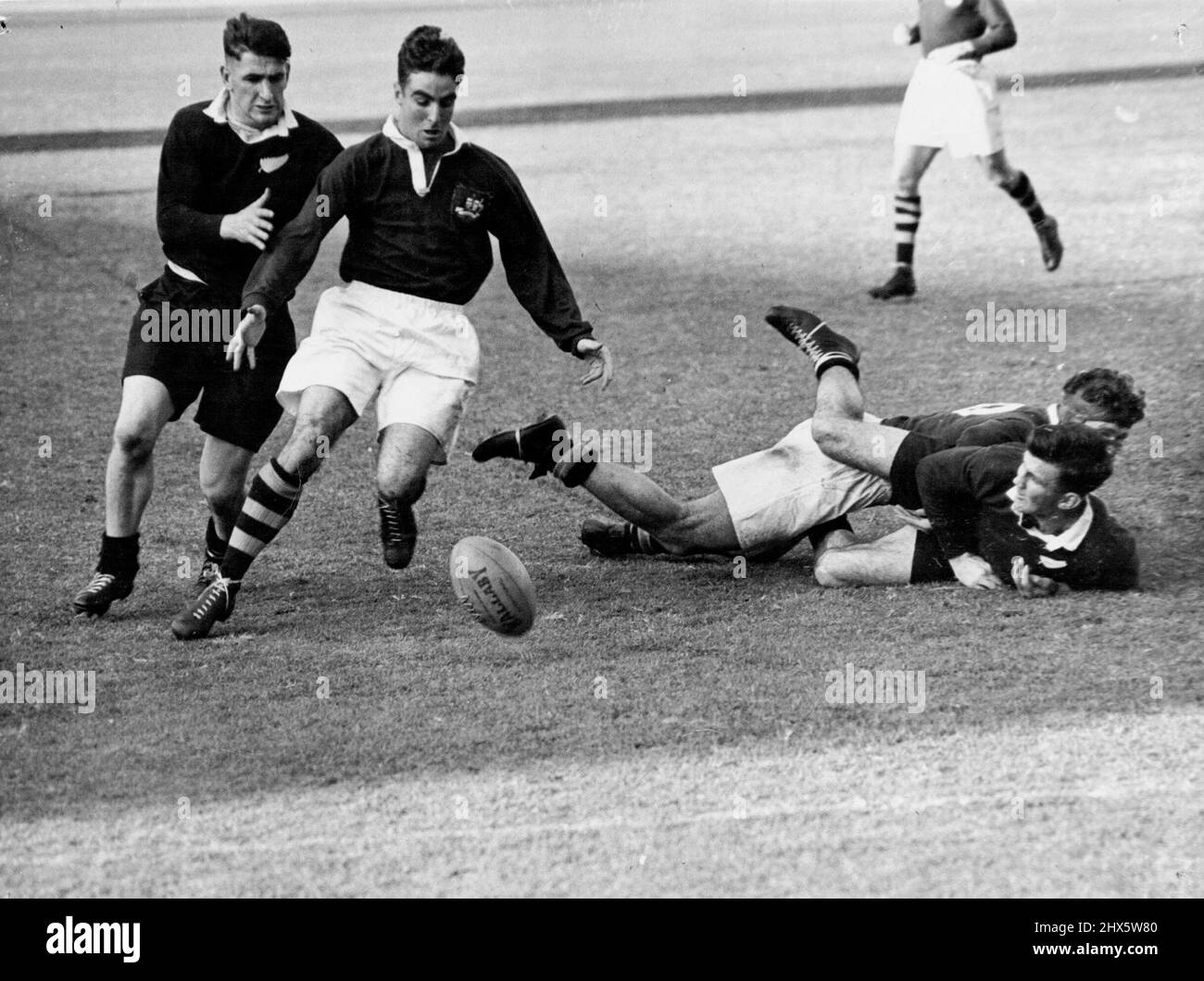 Lines for Rugby Union test pictures: No. 1 Rival centres Alan Walker (Aust White Shorts) (NZ) at left scrimmage for the ball. At inside centre, one favored position, Alan Walker races M. Goddard (NZ). July 01, 1947. Stock Photo