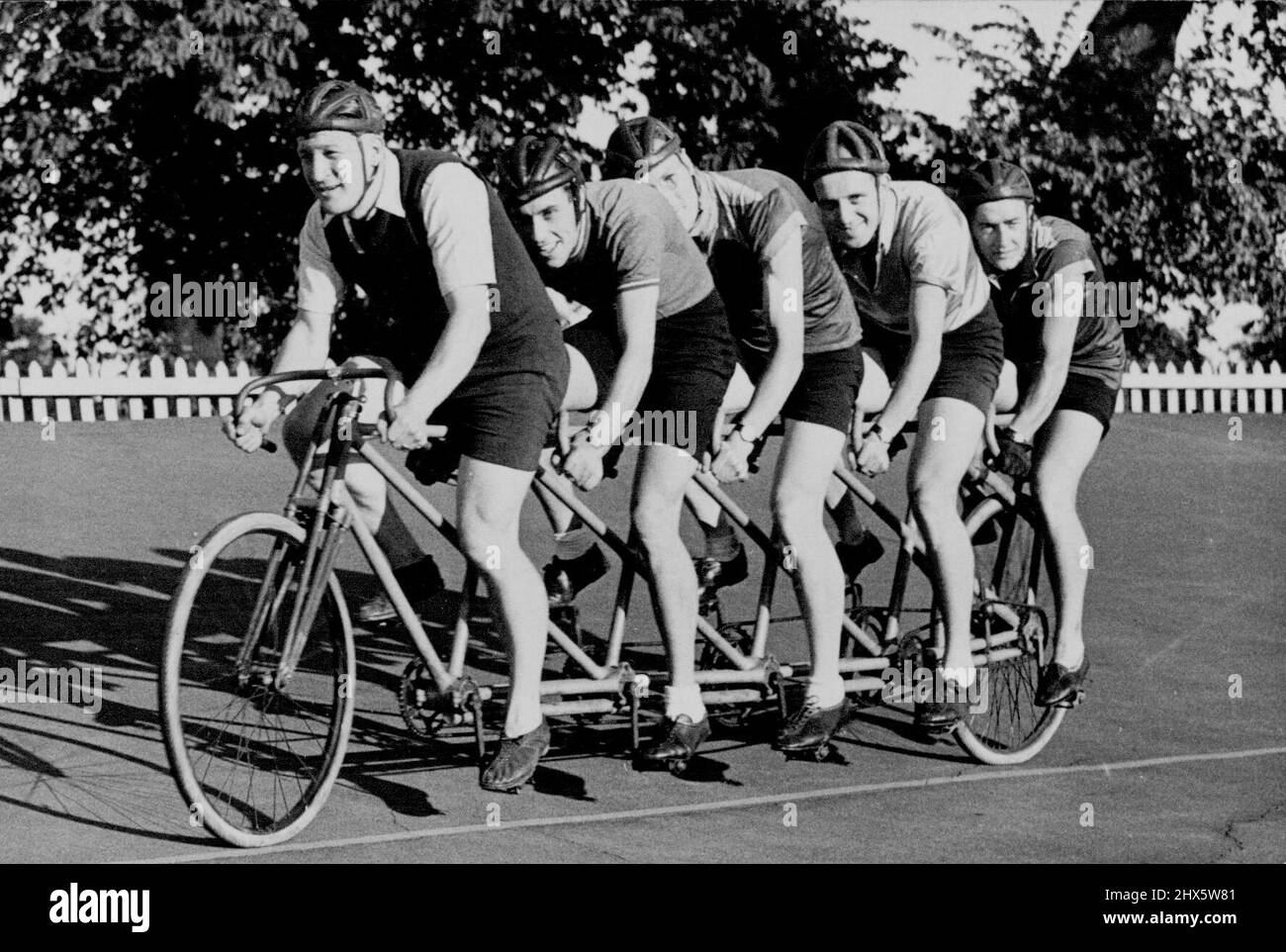 The 'Quint' Out For An Airing -- Trying out the 'Quint' at the Herne Hill track London. The 'Quint' or five seater cycle was actually built about 50 years ago but remained almost unused. It will be utised for incing purposes and demonstrations. August 6, 1949. (Photo by Sports And General Press Agency Limited). sports, sport, athlete, athletic, Stock Photo