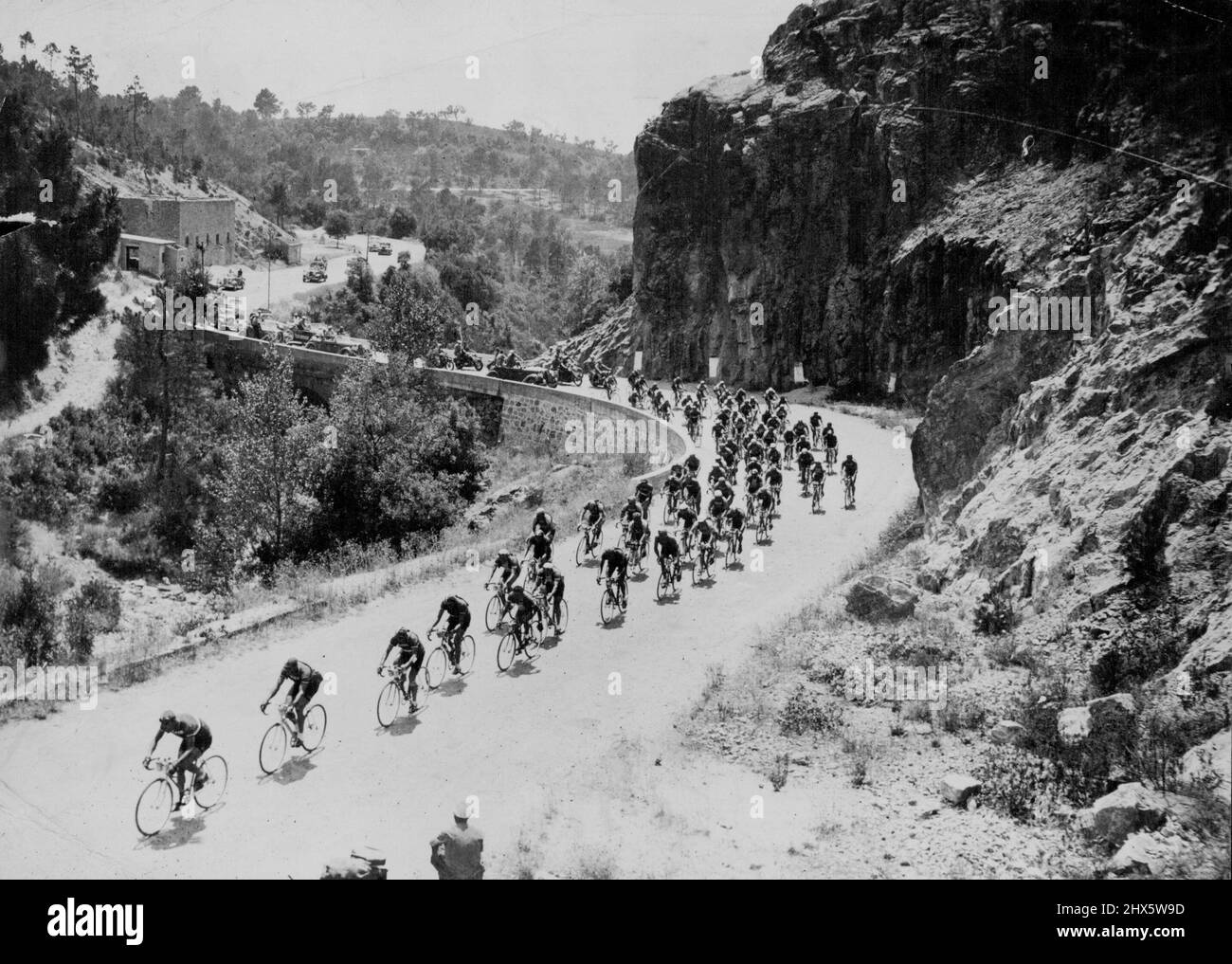 One of the many mountain climbs which make 'Le Tour' a back-breaking assignment for competitors. Having a French mountain village Tour de France competitors string out over a winding road on yet another stage of the 25-day ***** 3000 miles race. October 24, 1950. (Photo by Sports And General Press Agency Limited). sports, sport, athlete, athletic, Stock Photo