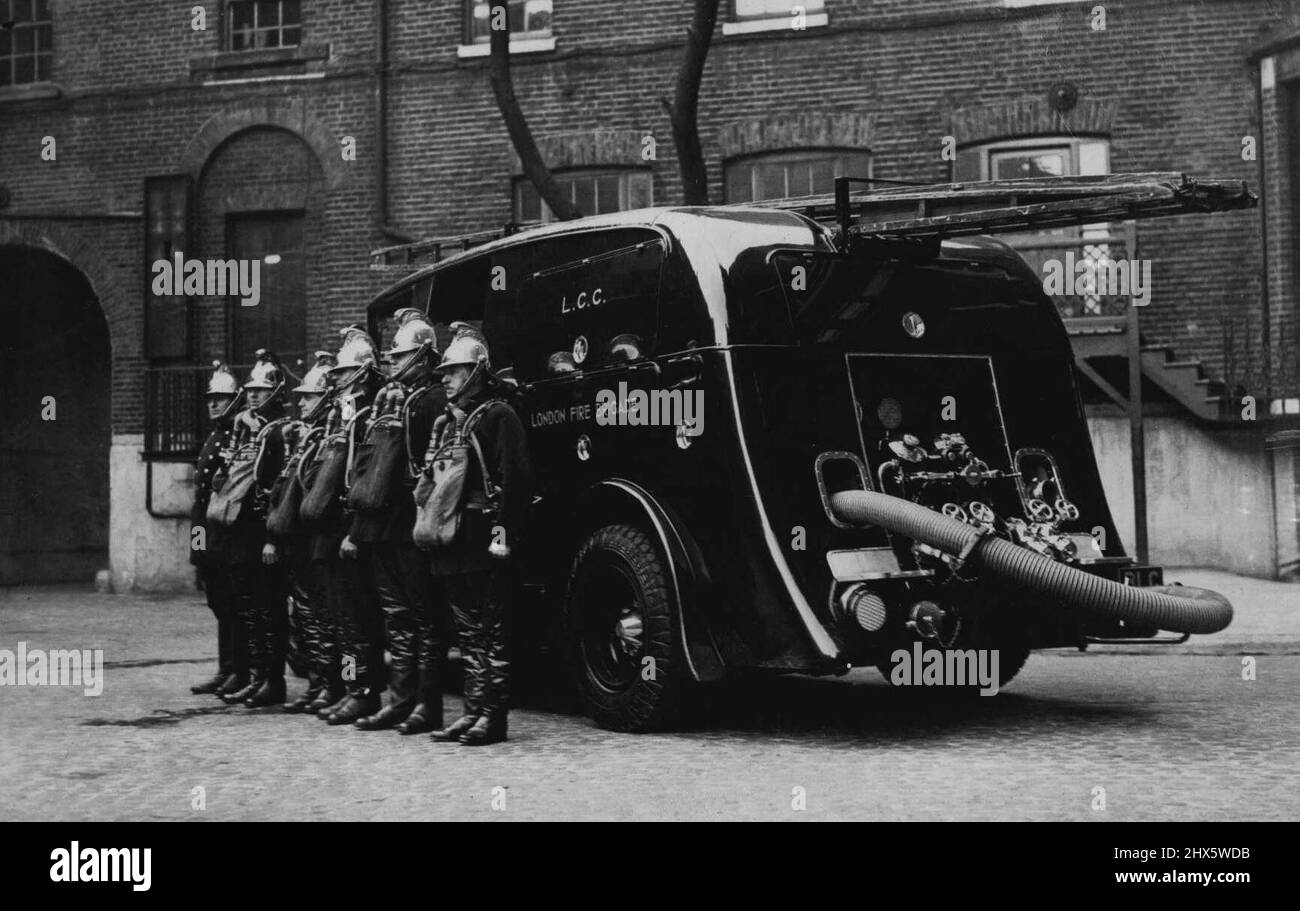 A Revolution In Fire Engines. New Strealined Saloon For London Fire Brigade. The new streamlined fire engine photographed on arrival at the Southwark Headquarters , showing the crew in their gasmasks standing beside it. The London Fire Brigade are going to cause a sensation with their new streamlined fire engine which they took delivery of at Guildford yesterday. It is streamliner, a saloon in which the driver and firemen are enclosed and protected from the weather. February 22, 1935. (Photo by Keystone). Stock Photo