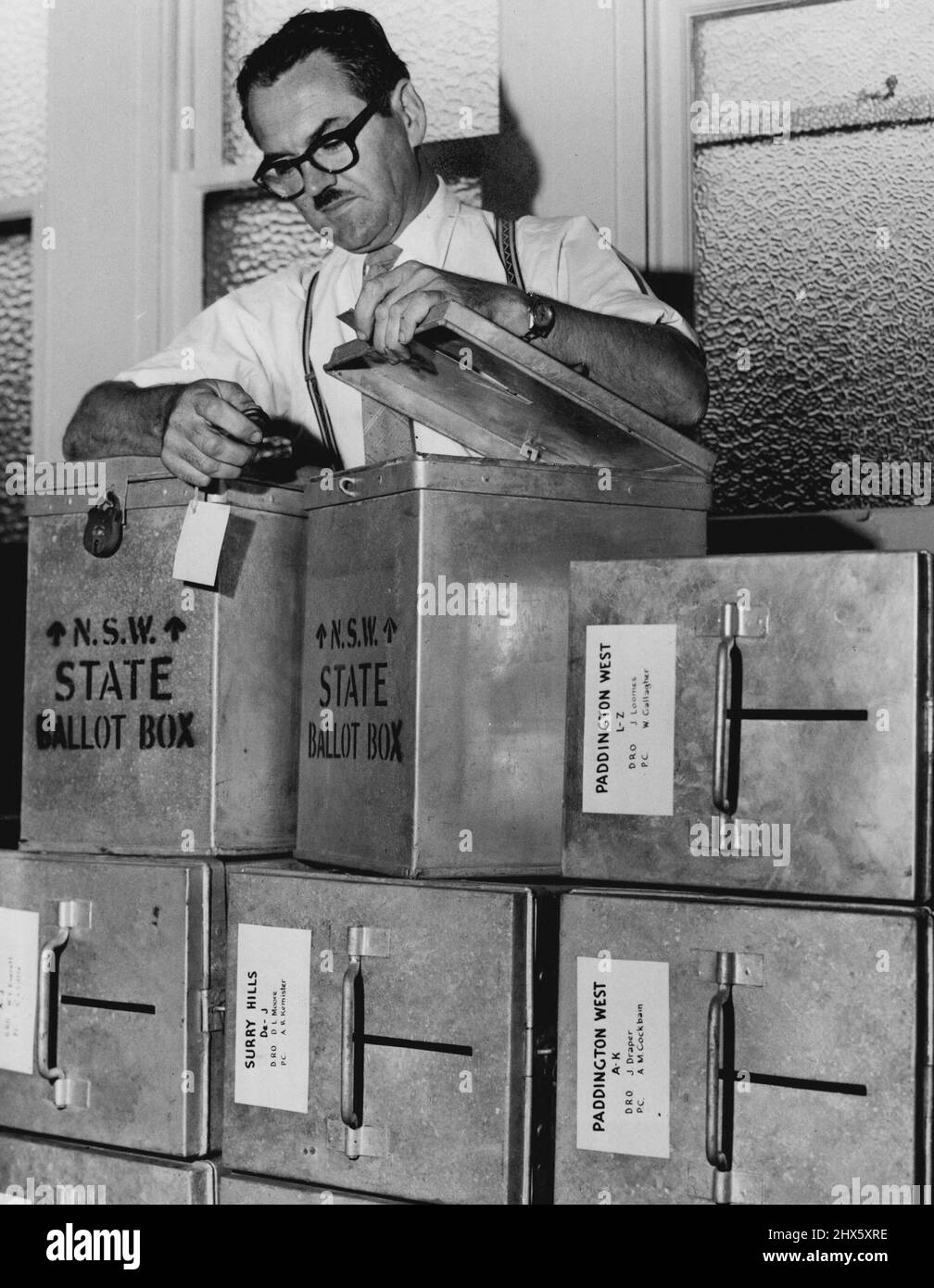 The State returning officer for the ***** electorate, Mr. J. H. Stubbs, locks up, yesterday, the last of 61 ballot boxes he will send to polling booths in his electorate for the referendum next Saturday. The boxes are stacked in Darlington Town Hall and will be taken to the polling booths later this week. April 25, 1961.;The State returning officer for the ***** electorate, Mr. J. H. Stubbs, locks up, yesterday, the last of 61 ballot boxes he will send to polling booths in his electorate for the Stock Photo