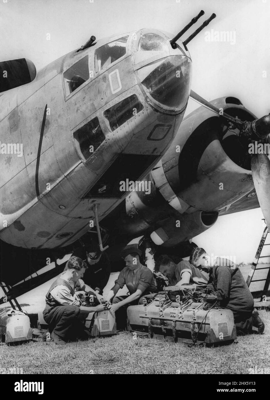 Loading The Incendiaries - Loading the incendiaries prior to a raid on enemy territory. Getting the first raising bombs into the R.A.F.'s latest Light Bomber, American produced 'Venturas' the name means 'Lucky Star', and is a fast twin engined machine, strongly armed. Hitler has recently ordered a complete overhaul of his A.R.P. Organisation. June 7, 1943. (Photo by Fox Photos).;Loading The Incendiaries - Loading the incendiaries prior to a raid on enemy territory. Getting the first raising bo Stock Photo